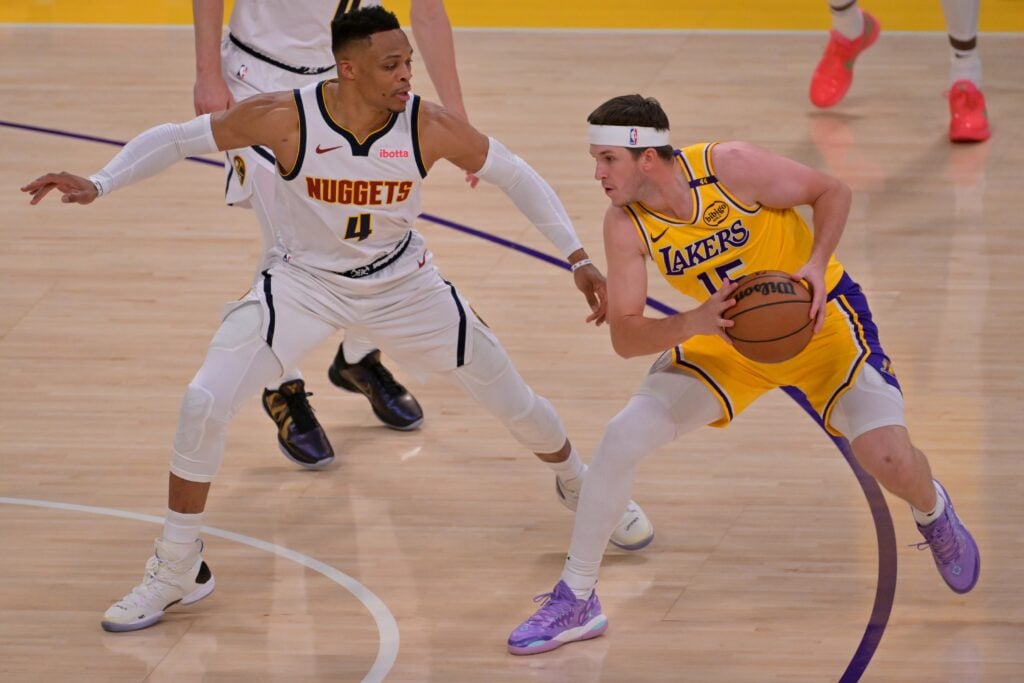 Mar 19, 2025; Los Angeles, California, USA; Denver Nuggets guard Russell Westbrook (4) defends Los Angeles Lakers guard Austin Reaves (15) in the first half at Crypto.com Arena. Mandatory Credit: Jayne Kamin-Oncea-Imagn Images