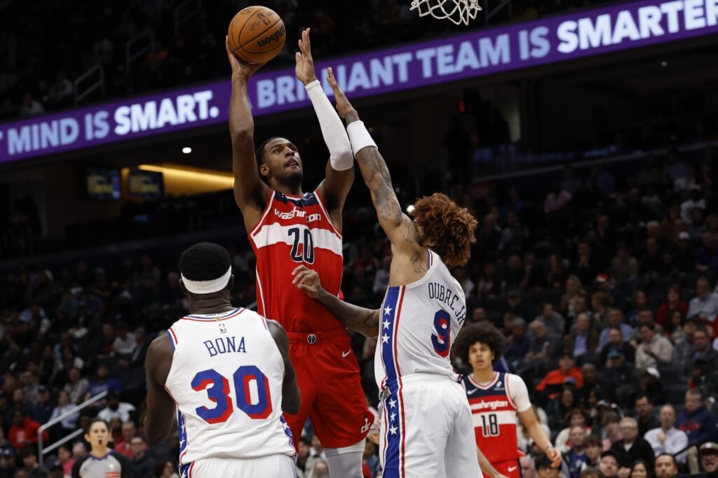 Oct 28, 2025; Washington, District of Columbia, USA; Washington Wizards center Alex Sarr (20) shoots the ball over Philadelphia 76ers guard Kelly Oubre Jr. (9) in the fourth quarter at Capital One Arena. Mandatory Credit: Geoff Burke-Imagn Images