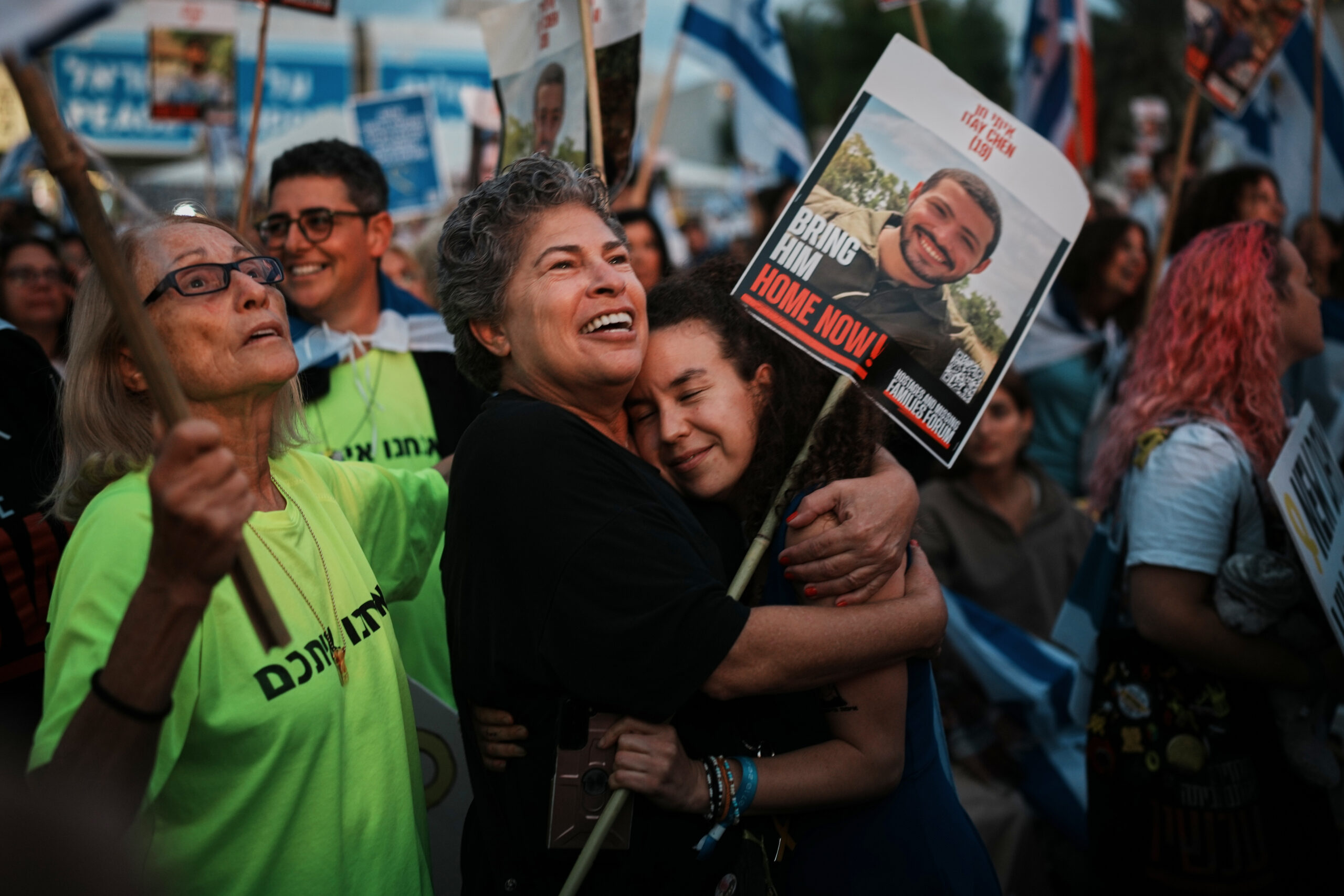People gather prior to the release of Israeli hostages held...