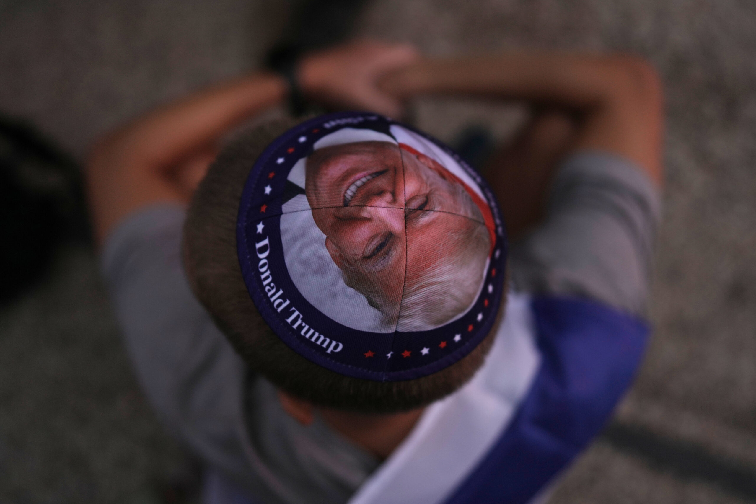 A Jewish man wears a kippah printed with the image...