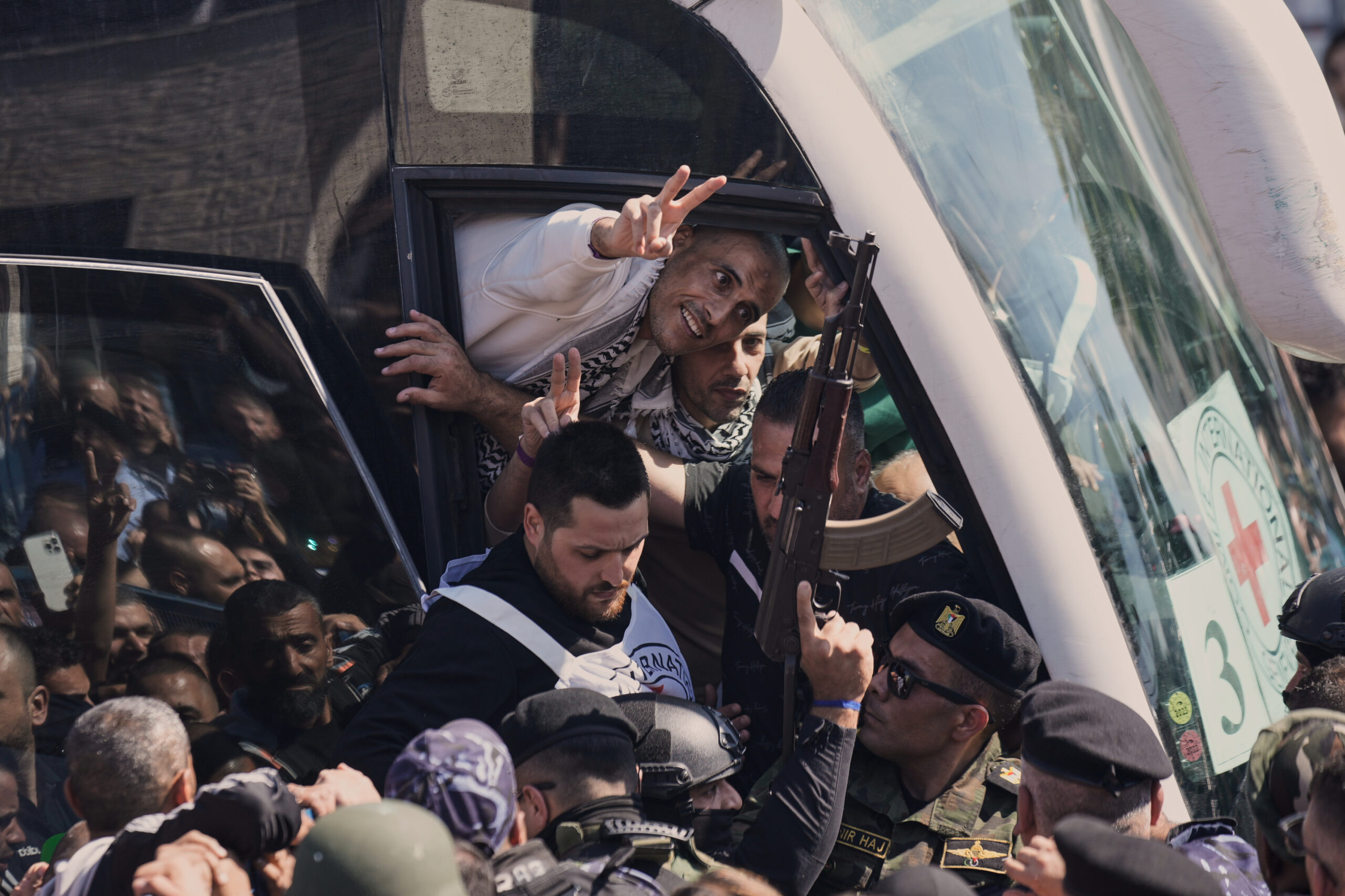 A Palestinian prisoner makes the victory sign after being released...