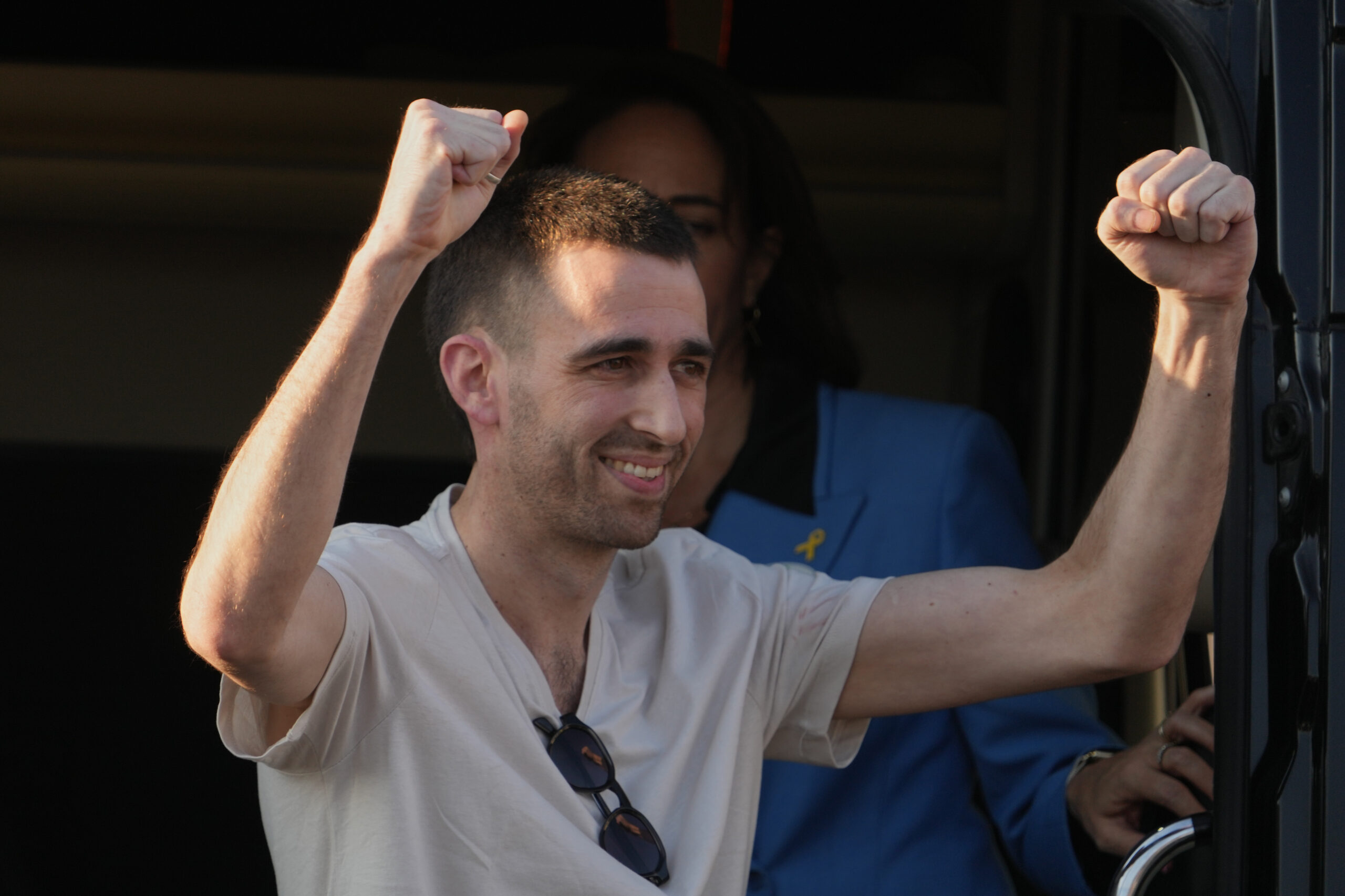 Freed Israeli hostage Avinatan Or gestures from a van as...