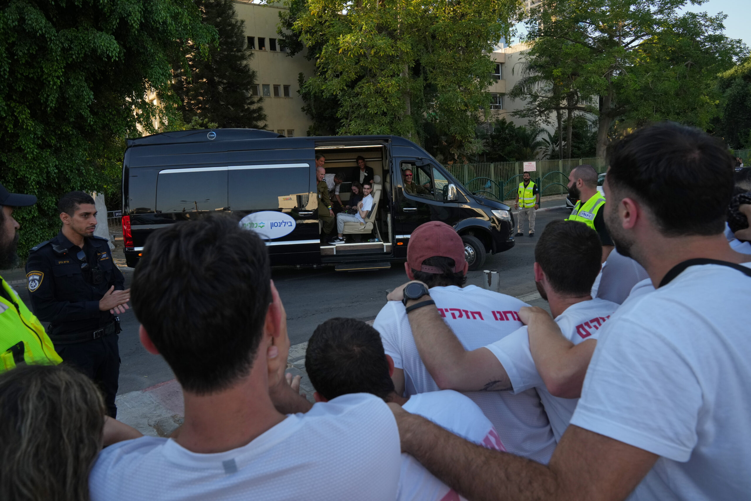 Freed Israeli hostage Evyatar David gestures from a van as...
