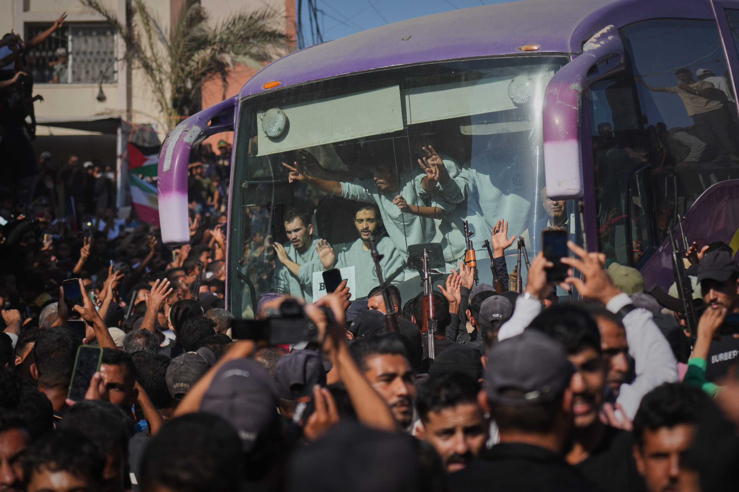 People greet freed Palestinian prisoners arriving on buses in the...