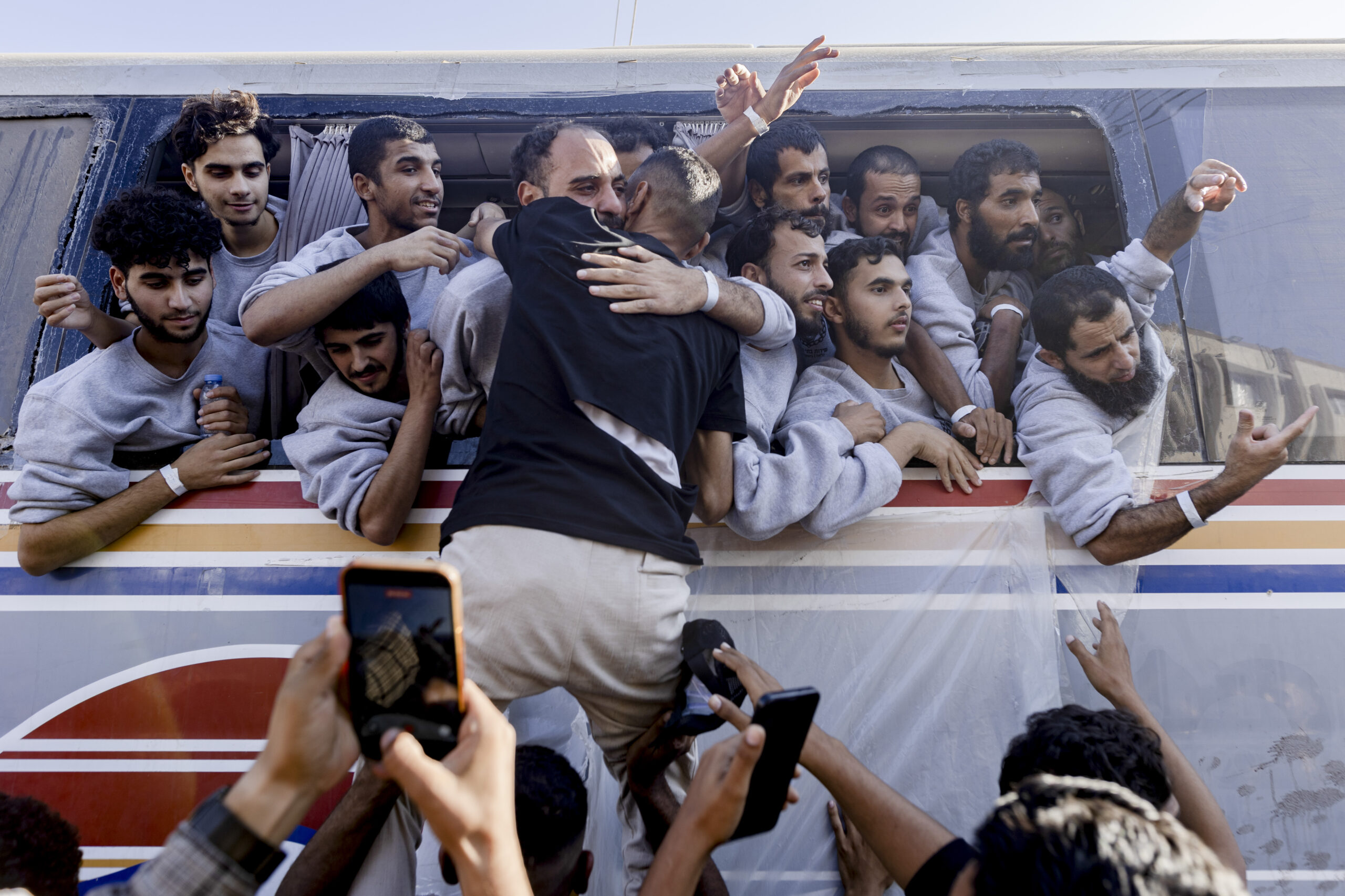 Palestinian prisoners released by Israel wave from a bus as...