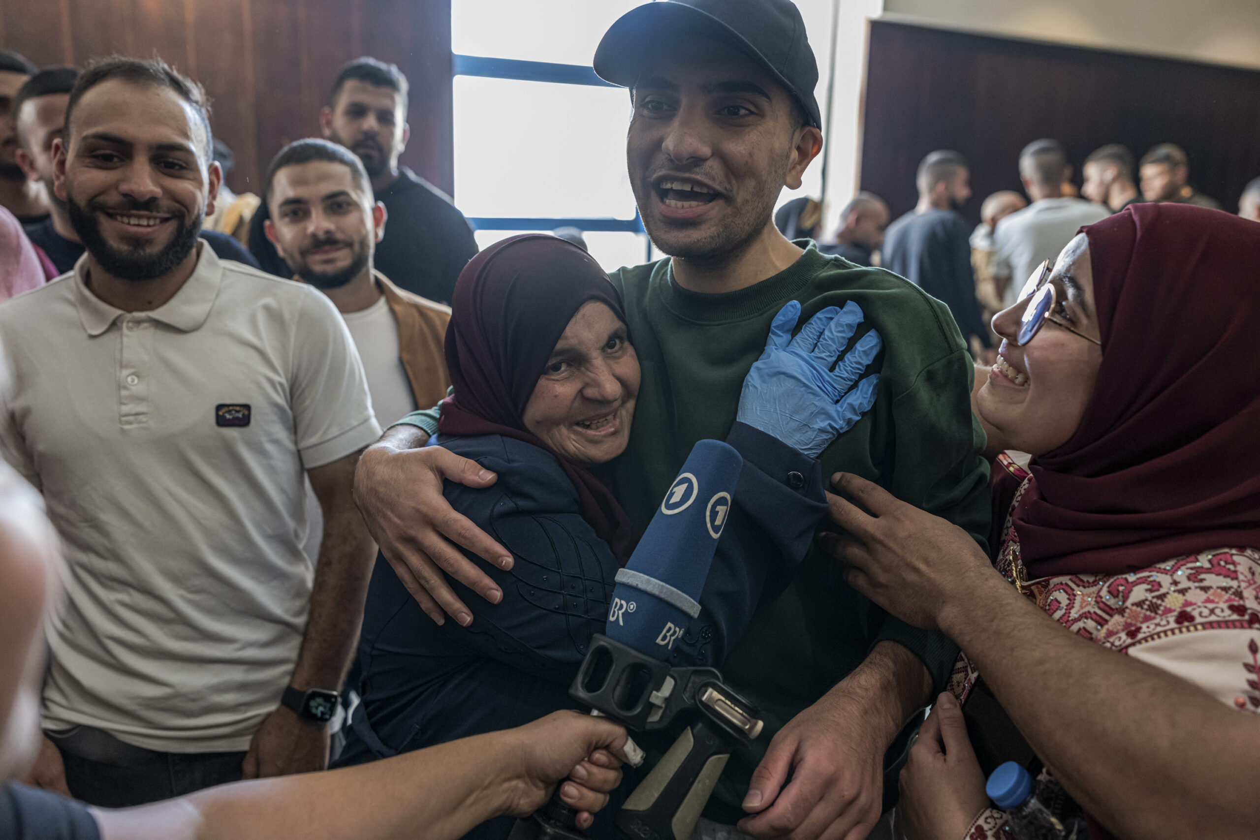 Palestinians celebrate as released Palestinian prisoners arrive after an exchange...