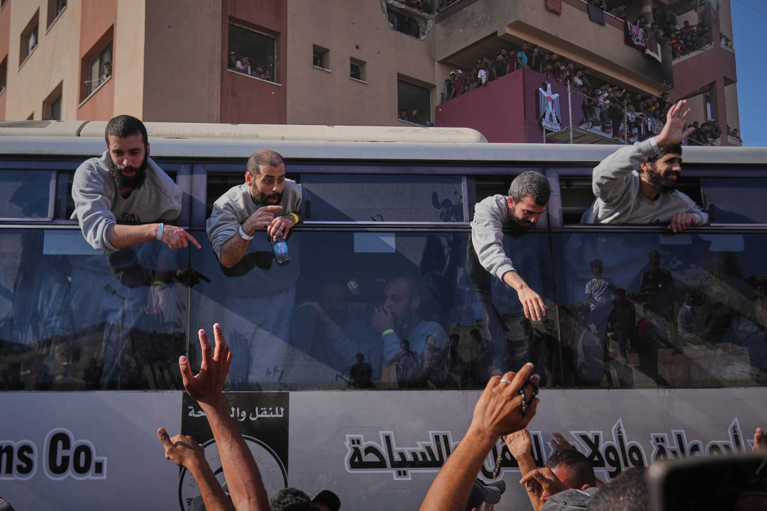 People greet freed Palestinian prisoners arriving on buses in the...