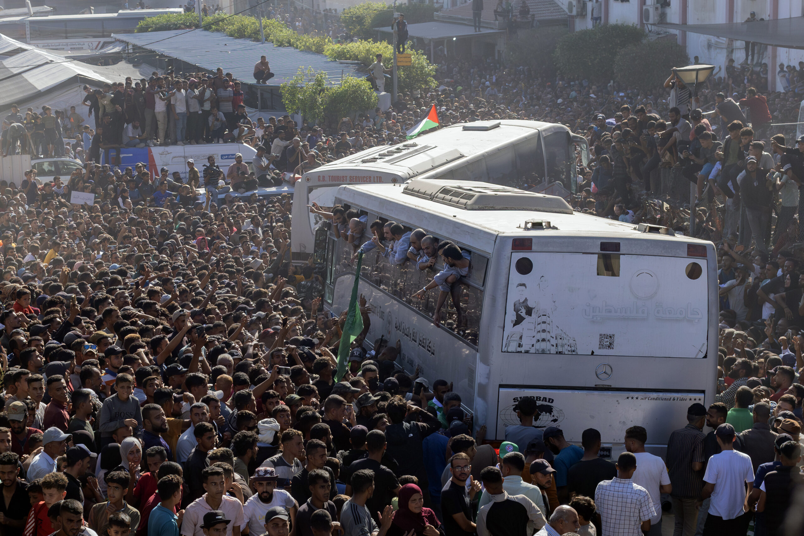 A cheering throng greets Palestinian prisoners released by Israel as...