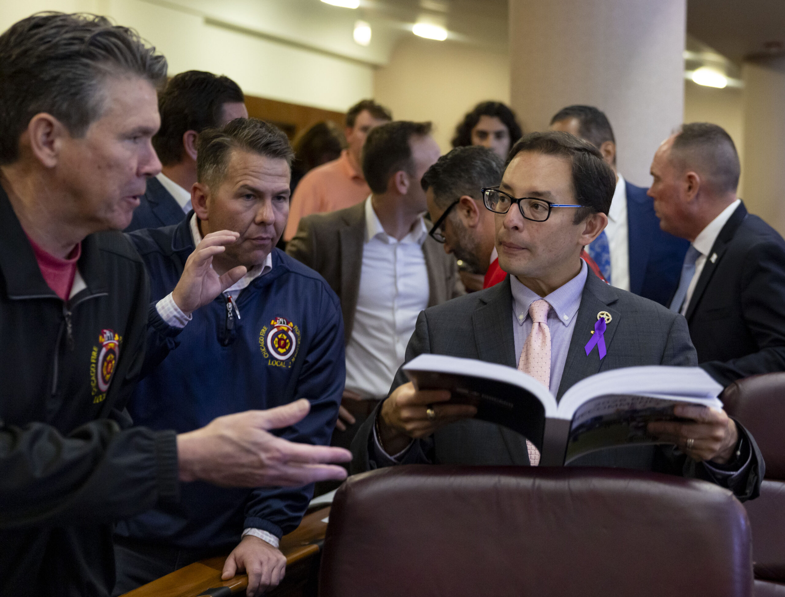 Ald. Raymond Lopez, 15th, looks at the proposed budget with...