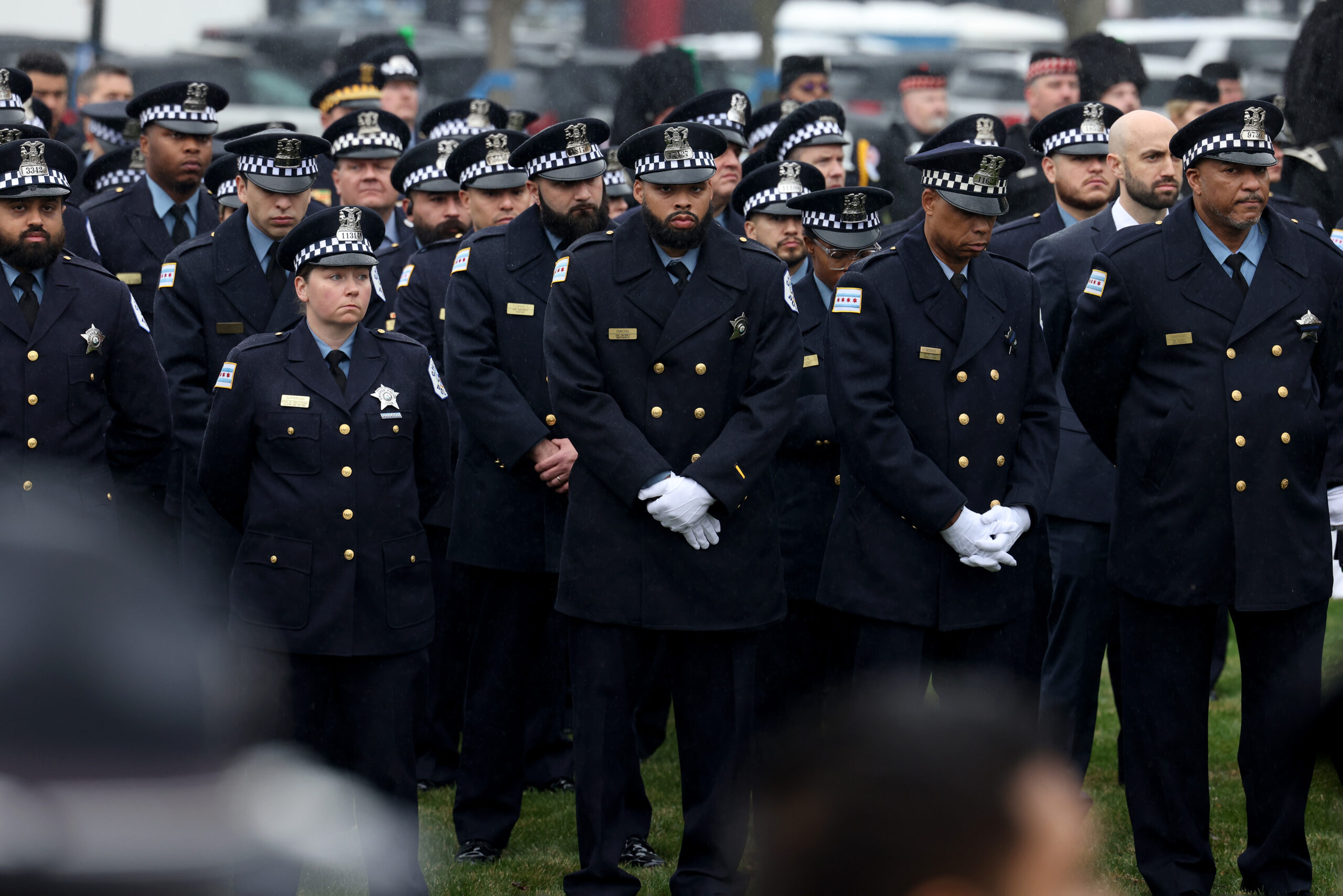 Police officers look on as the procession arrives at the...