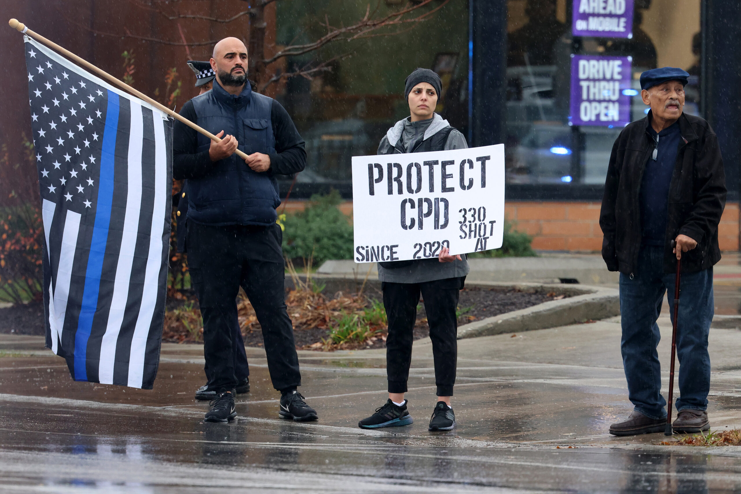 People supporting the Chicago Police Department await the procession of...
