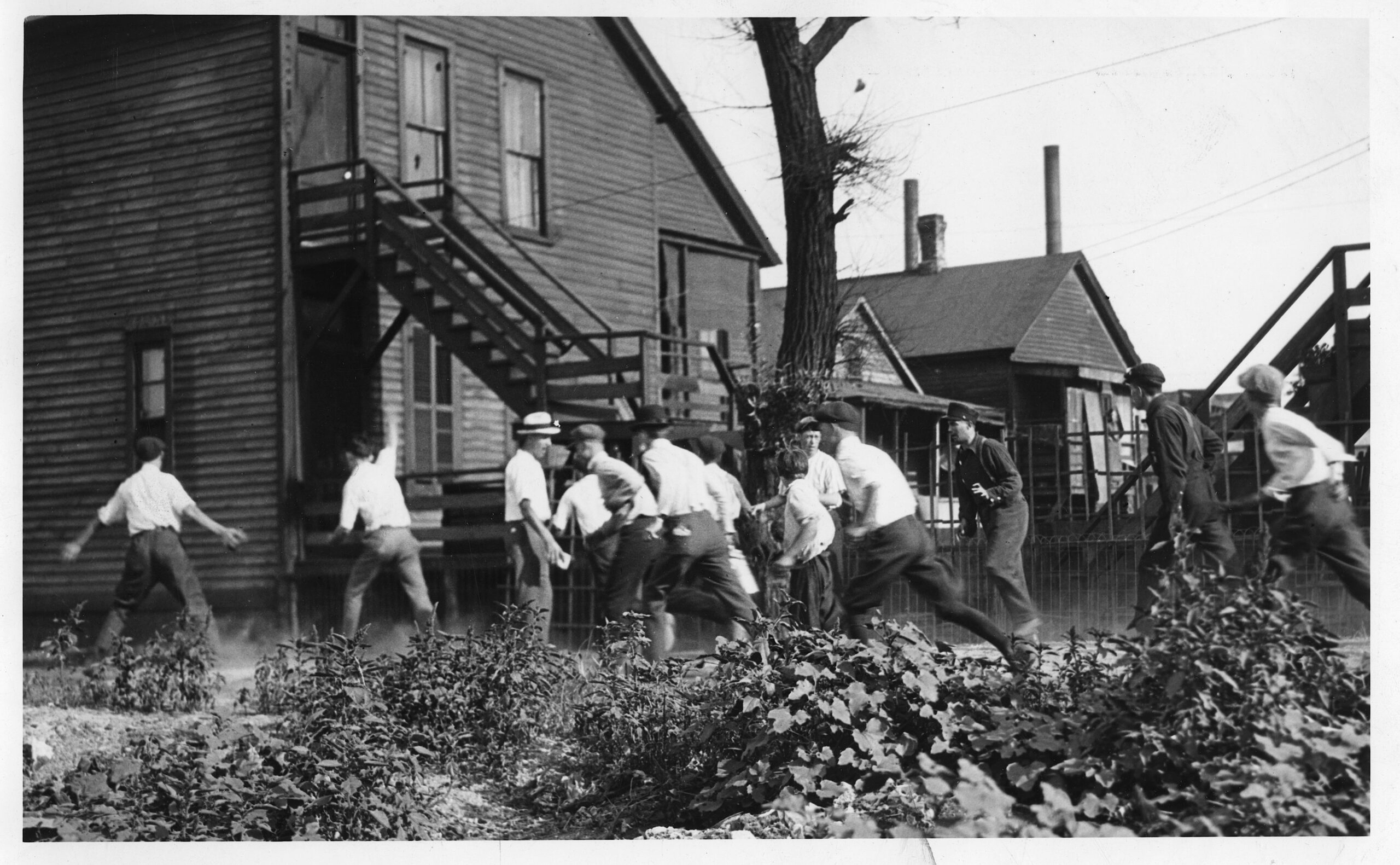Rioters attack a Black man under the corner of a...