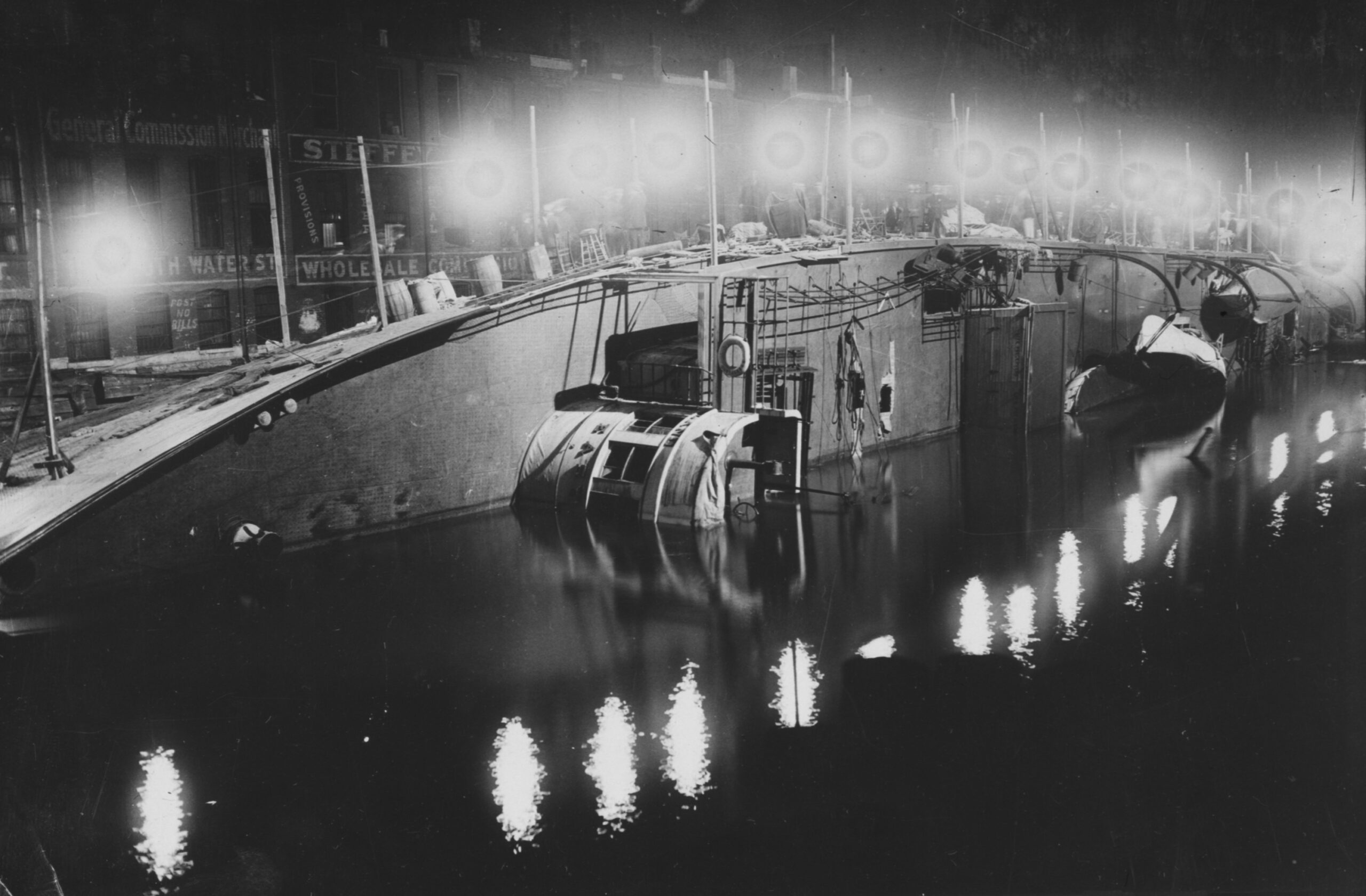The SS Eastland is illuminated at night as workers continue...