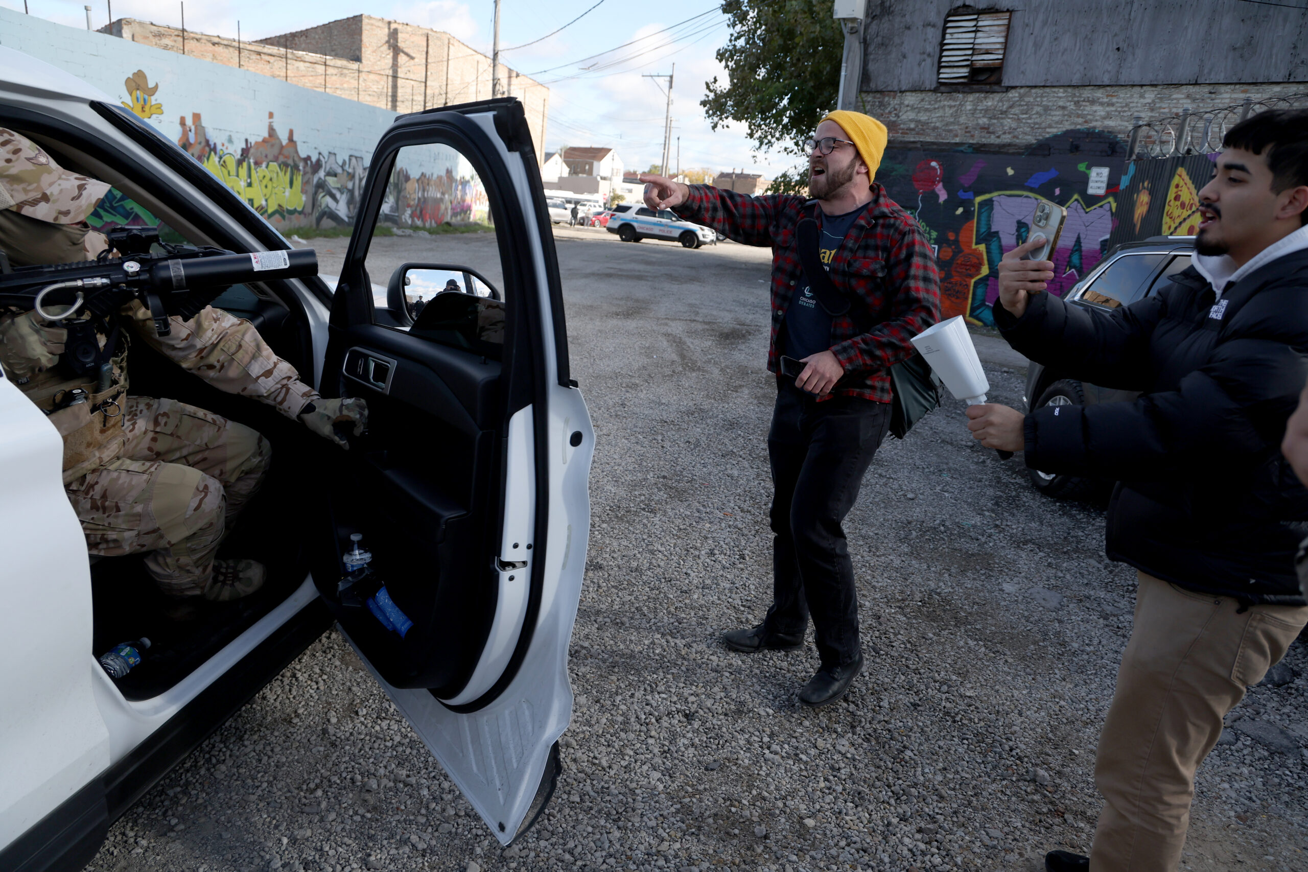 A federal agent points his weapon out the window as...