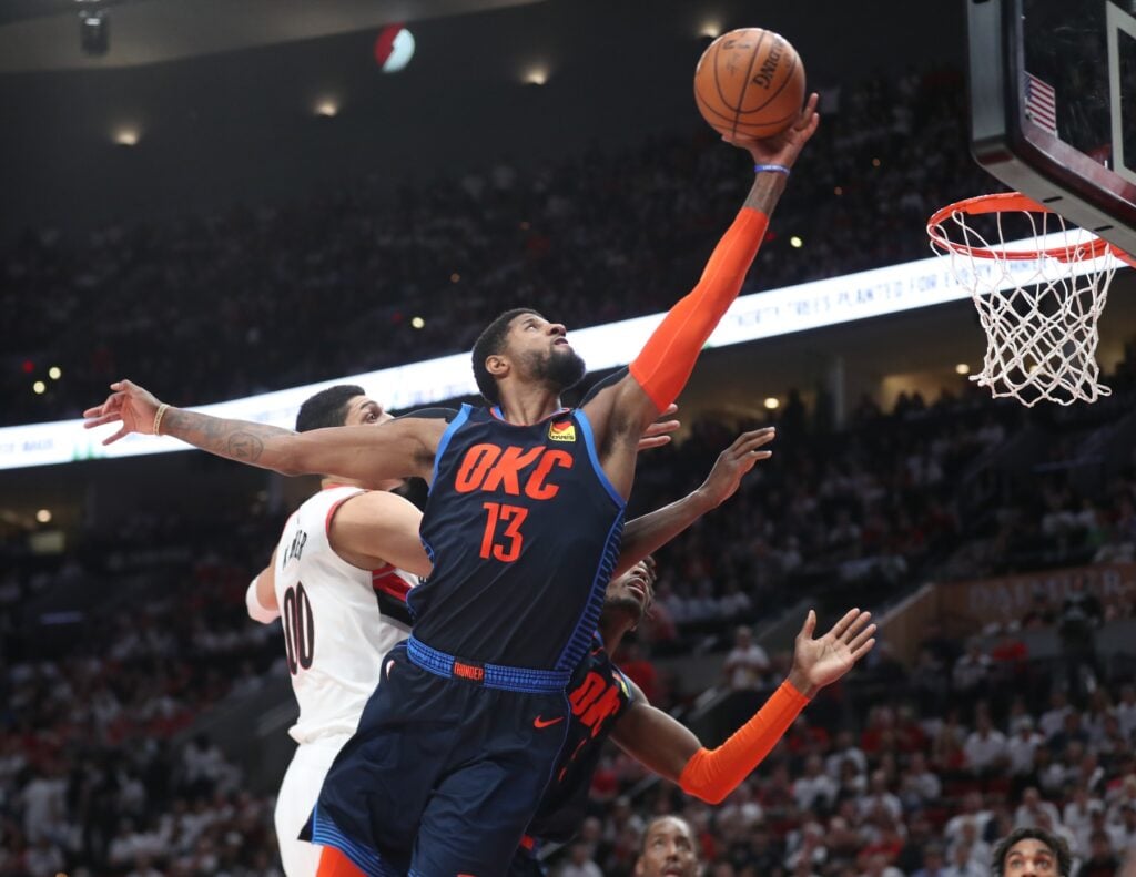  Oklahoma City Thunder forward Paul George (13) shoots over Portland Trail Blazers center Enes Kanter (00) in the second half of game five of the first round of the 2019 NBA Playoffs at Moda Center.