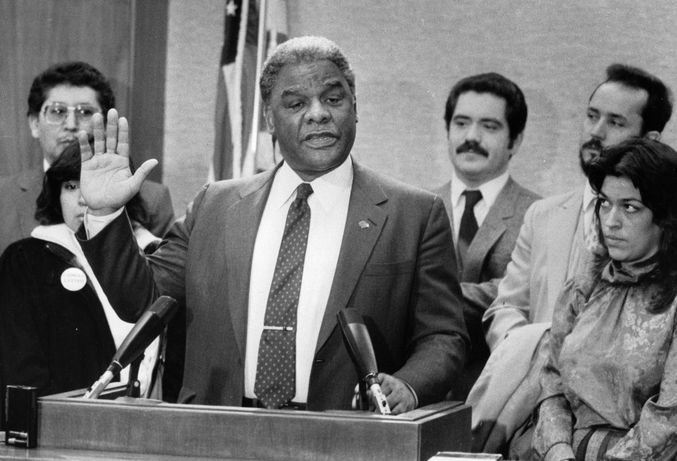 Mayor Harold Washington raises his hand as he talks about...