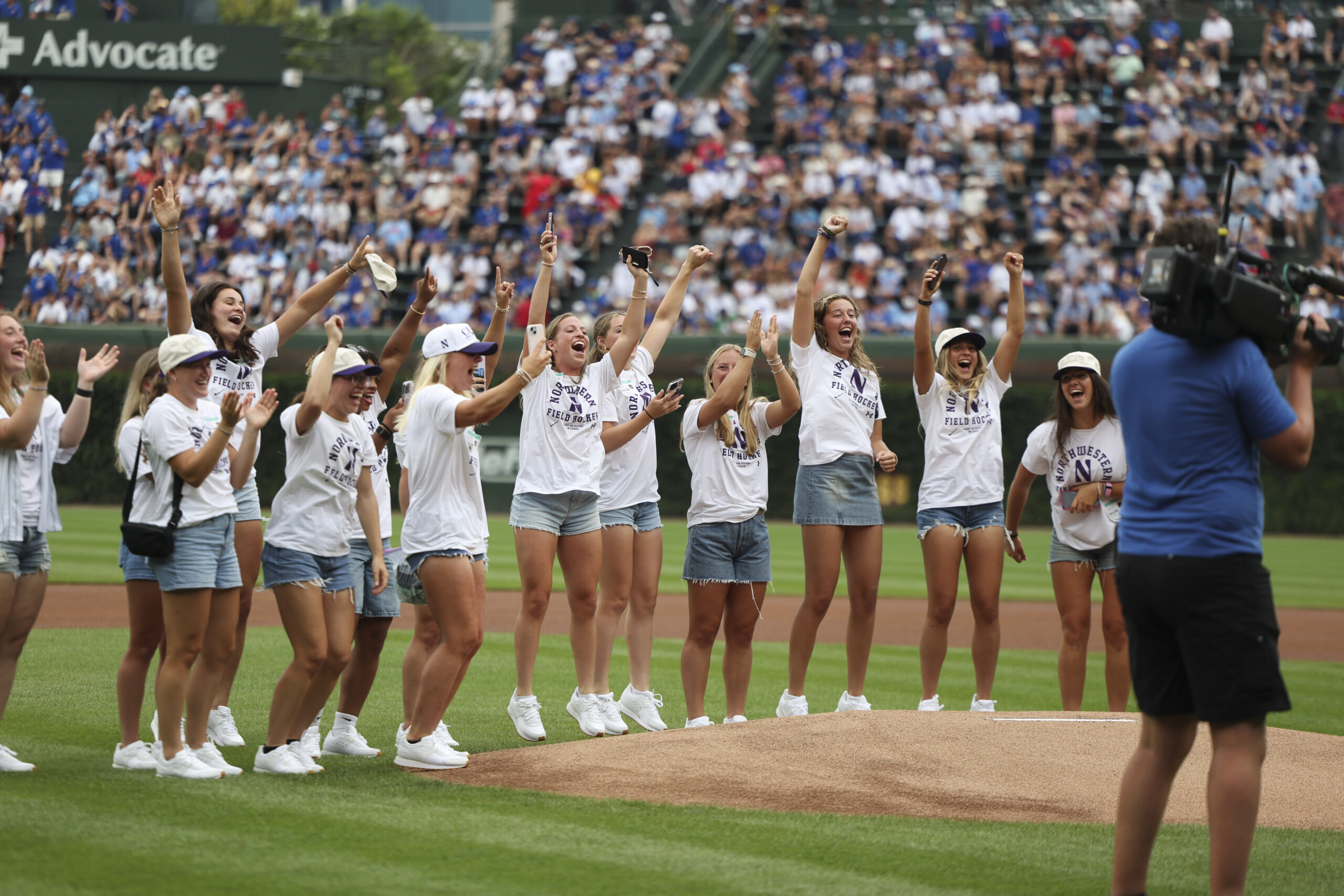 Northwestern University field hockey players cheer after their teammate threw...