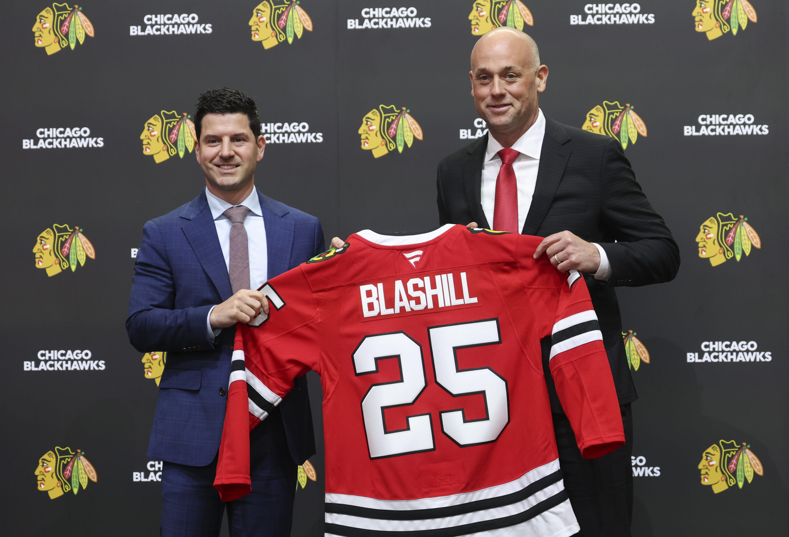 Chicago Blackhawks General Manager Kyle Davidson, left, poses with new...