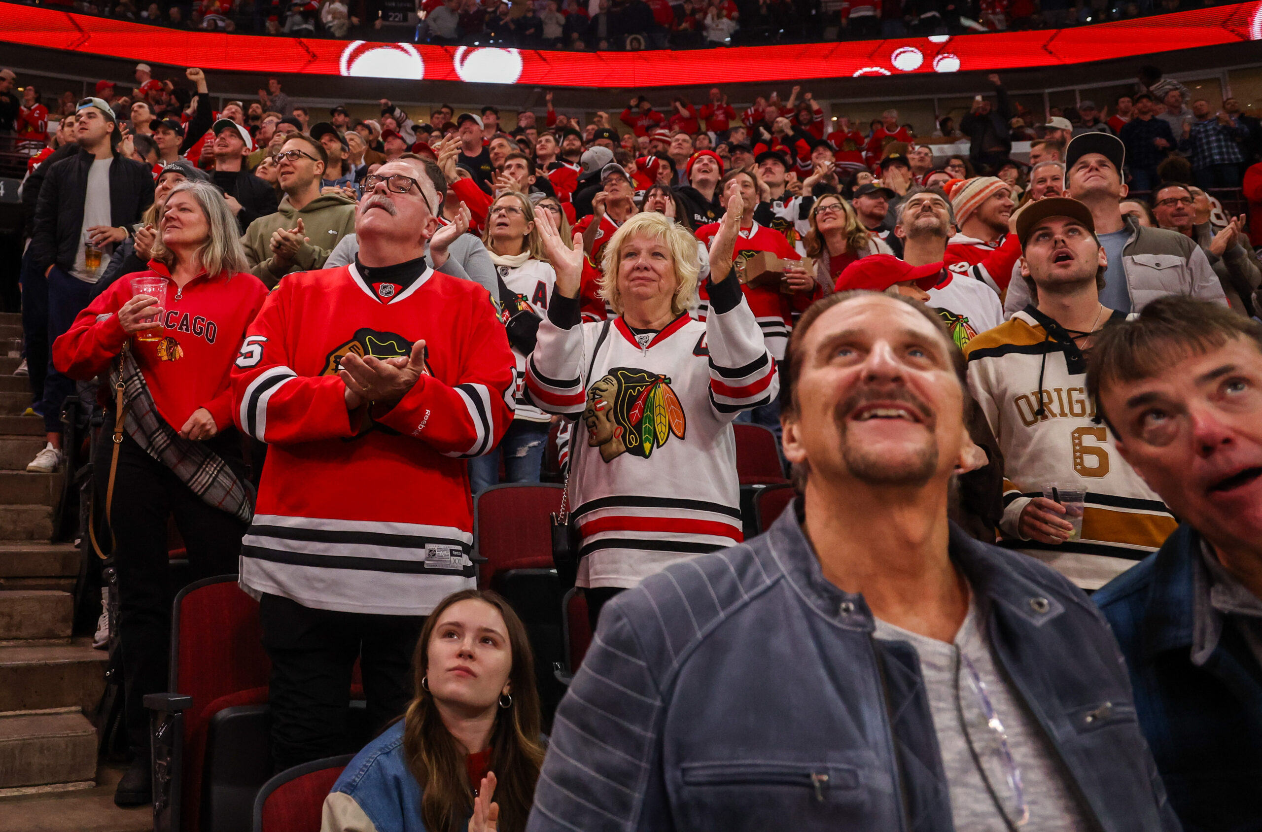 Fans cheer after Blackhawks center Connor Bedardâs (98) first goal...