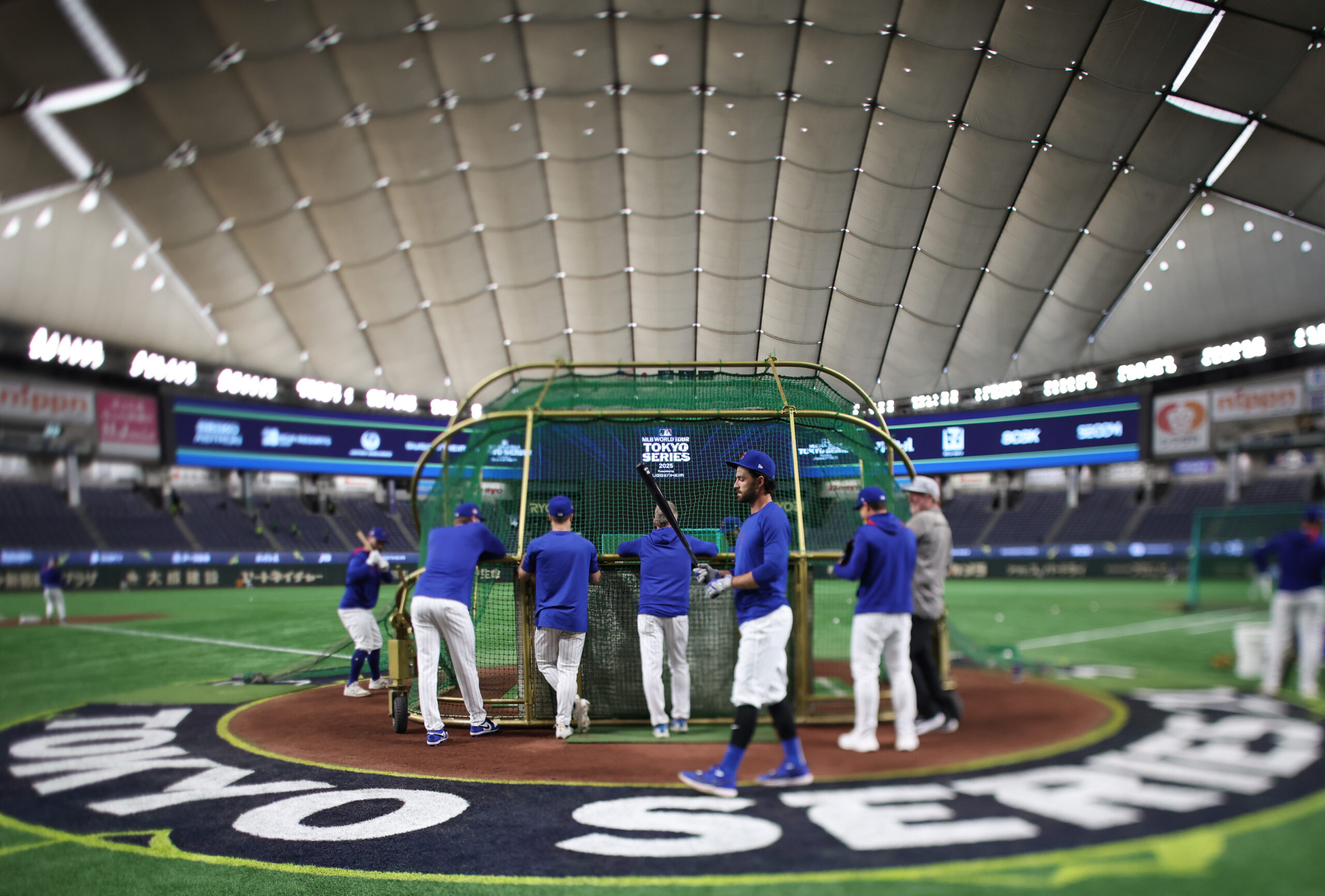 Cubs shortstop Dansby Swanson, center right, waits for his turn...