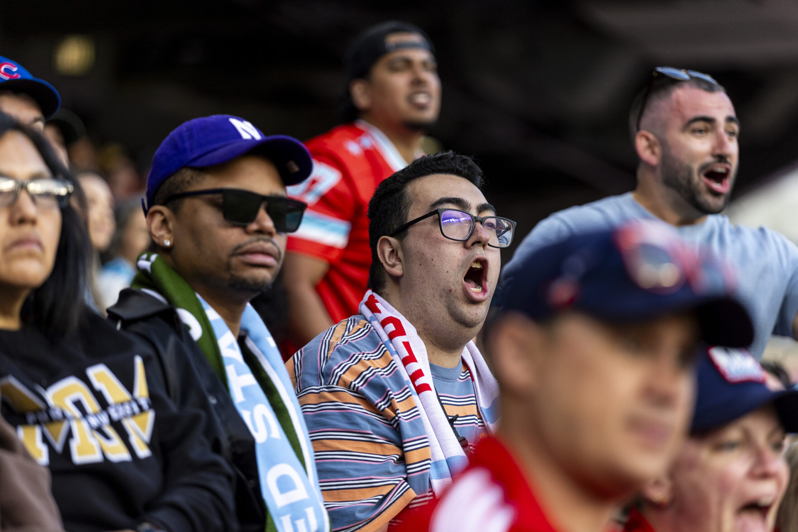 Fire fan Tyler Compoz, center, yells for what he thought...