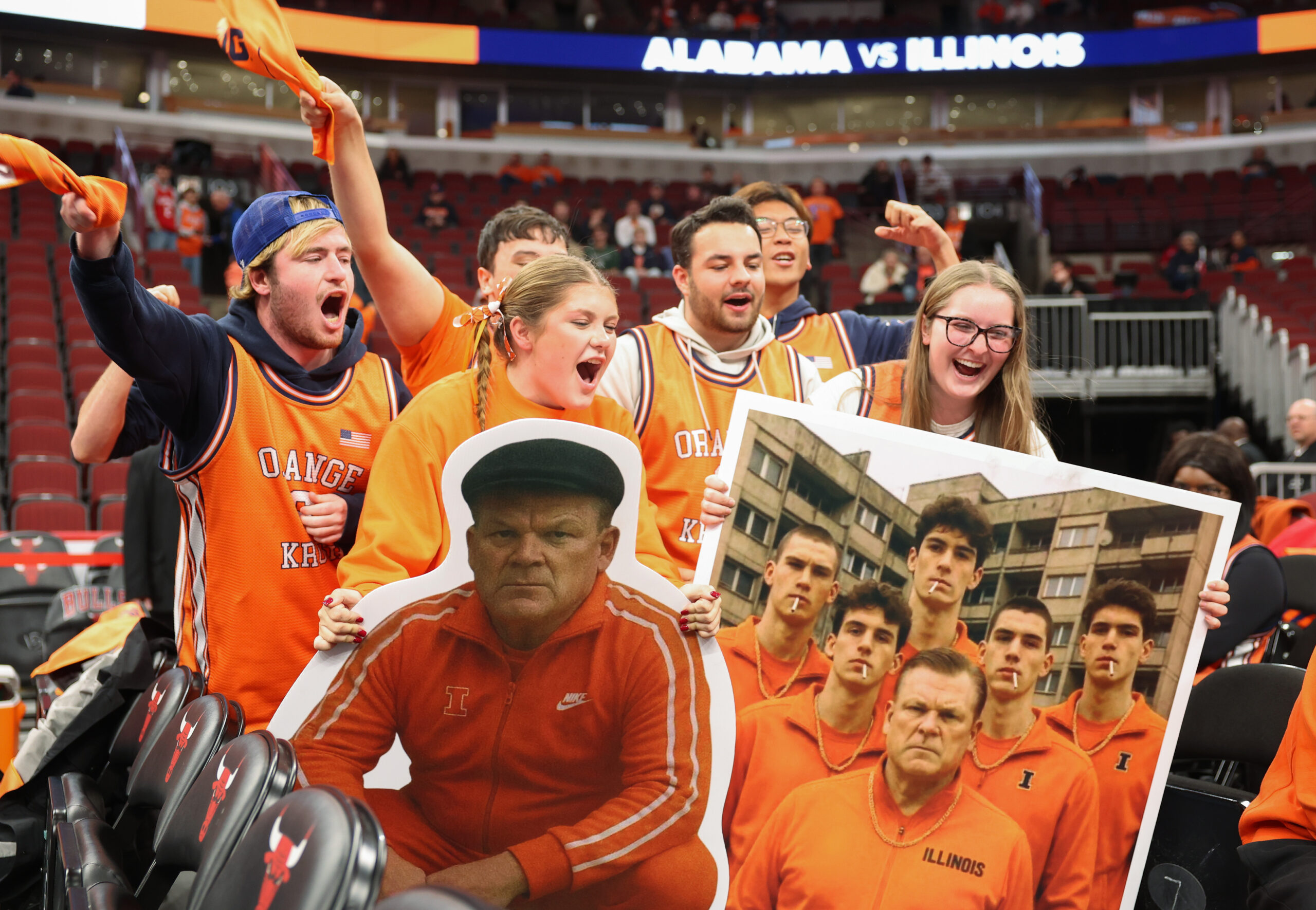 Illinois student fans hold a cutout of coach Brad Underwood...