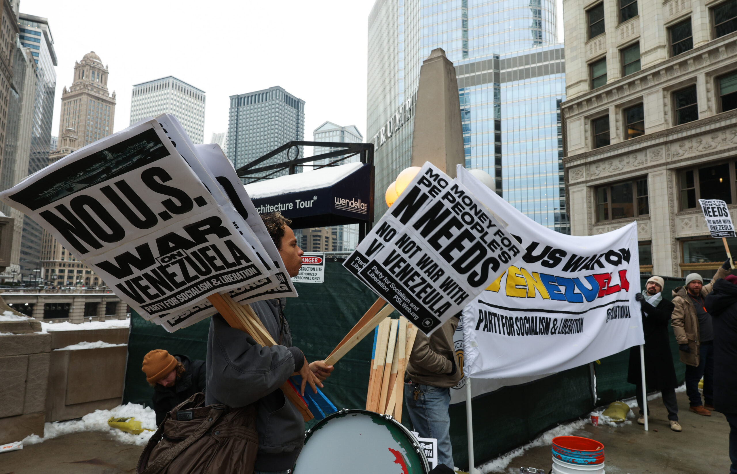 Emil Mitchell holds protest signs to distribute during a demonstration...