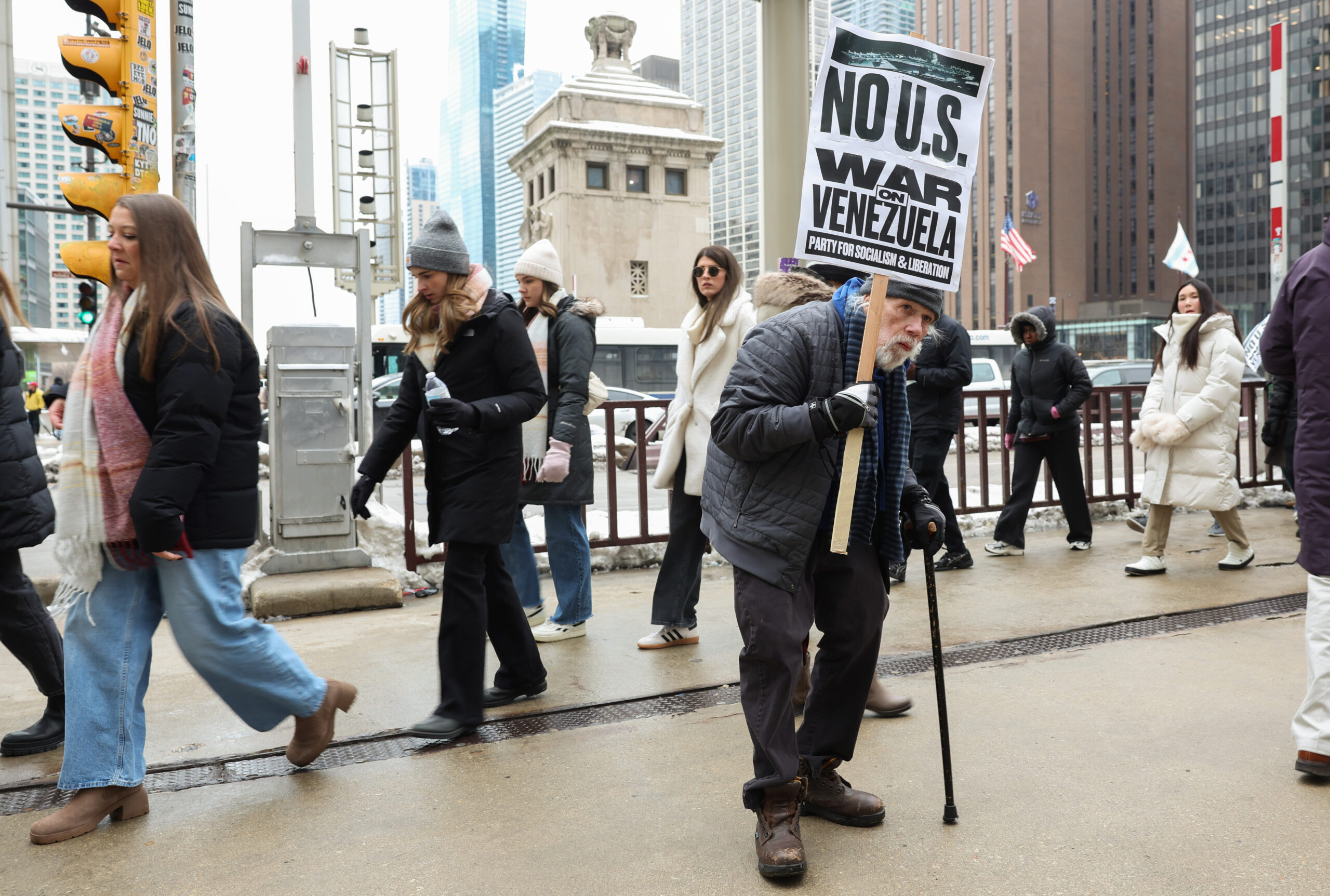 People pass by as Austin Mindnich, of South Bend, Indiana,...