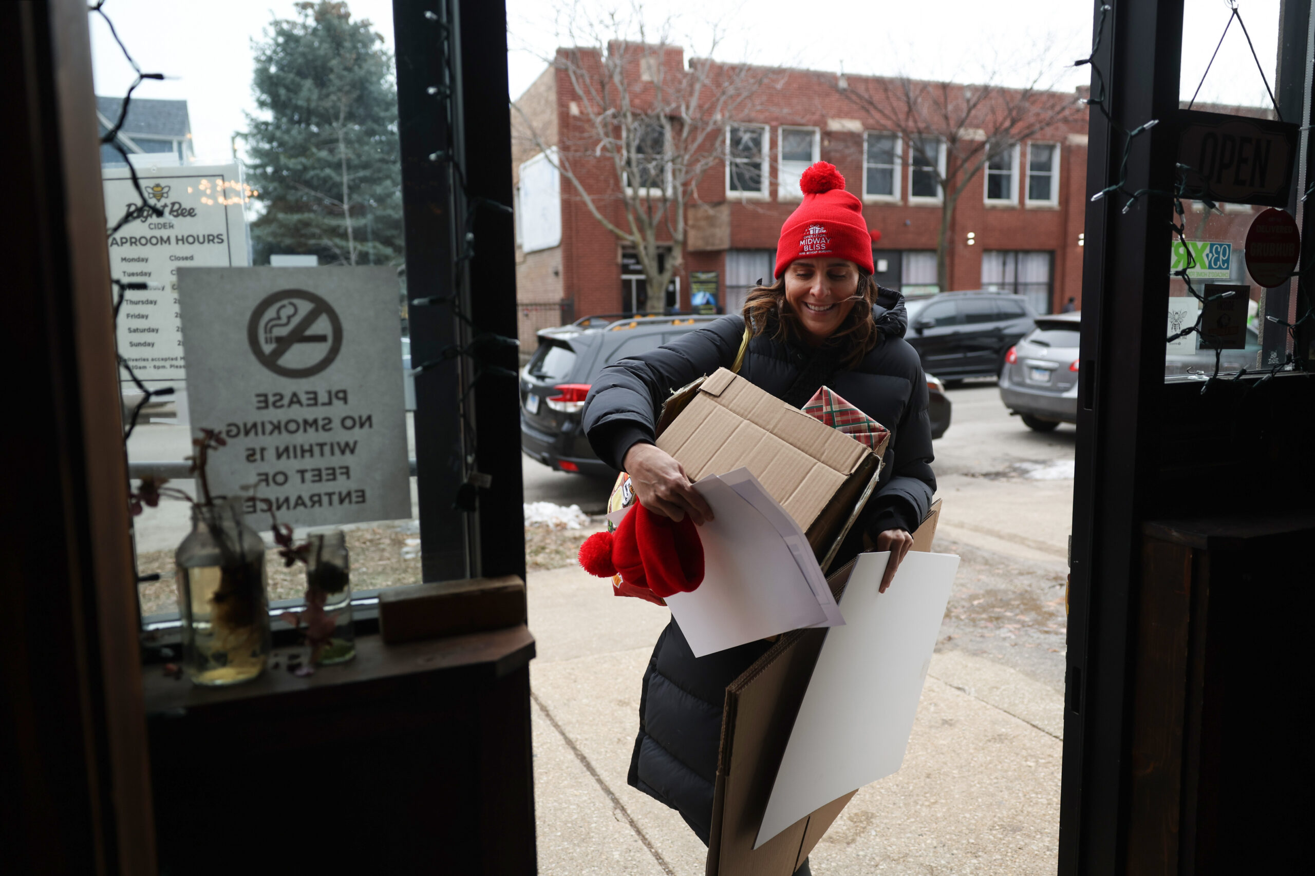 Taylor Krahl hauls volunteer sign-in equipment before a food distribution...