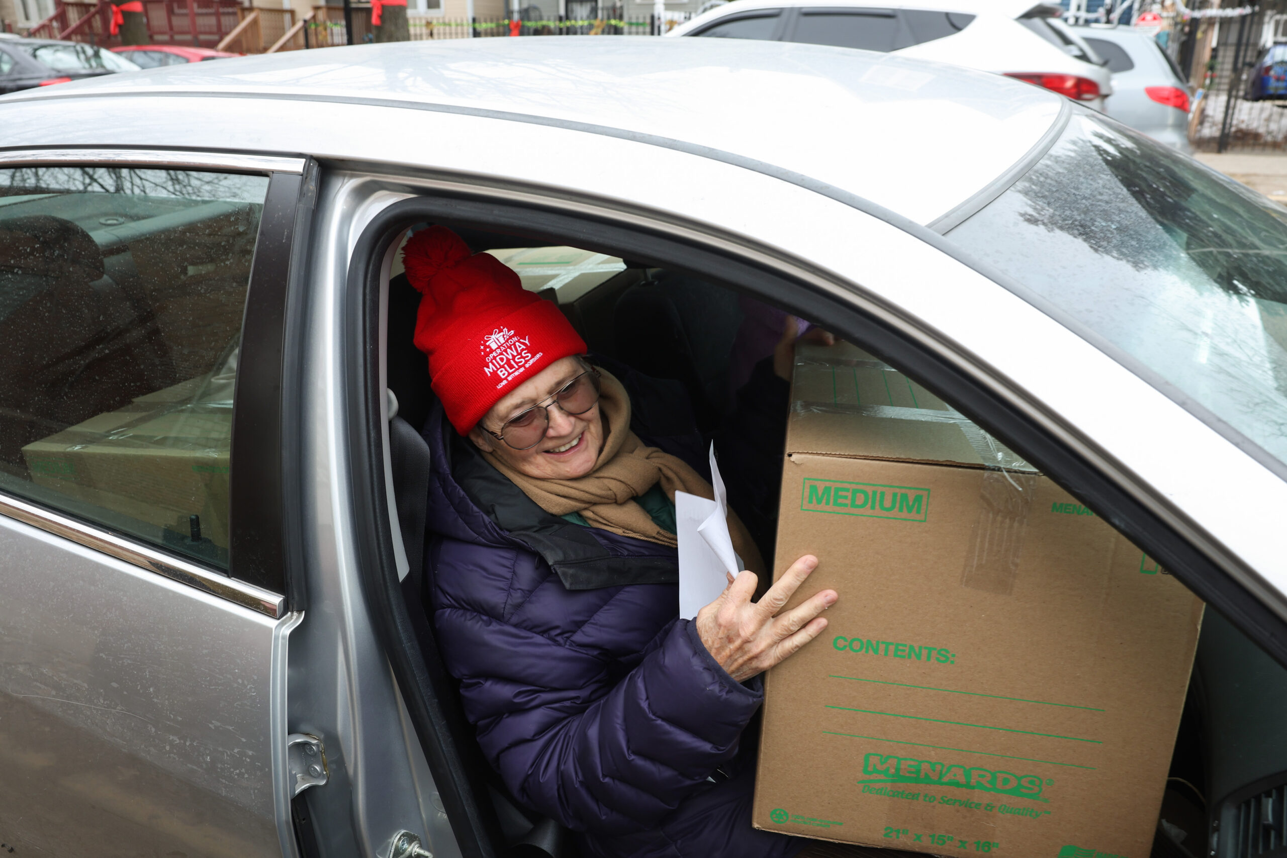 Volunteer Valerie Booth holds on her lap one of several...