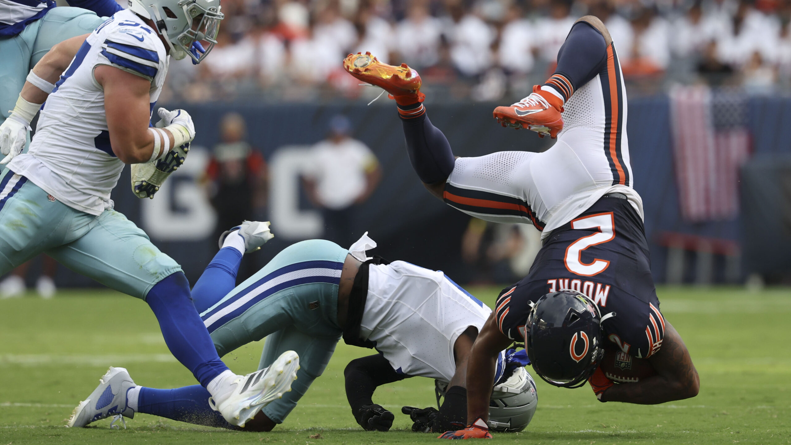 Sept. 21: Chicago Bears wide receiver DJ Moore, right, tumbles...