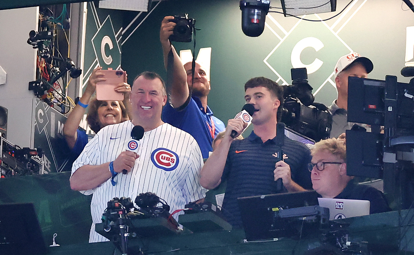 Illinois football coach Bret Bielema and quarterback Luke Altmyer sing...