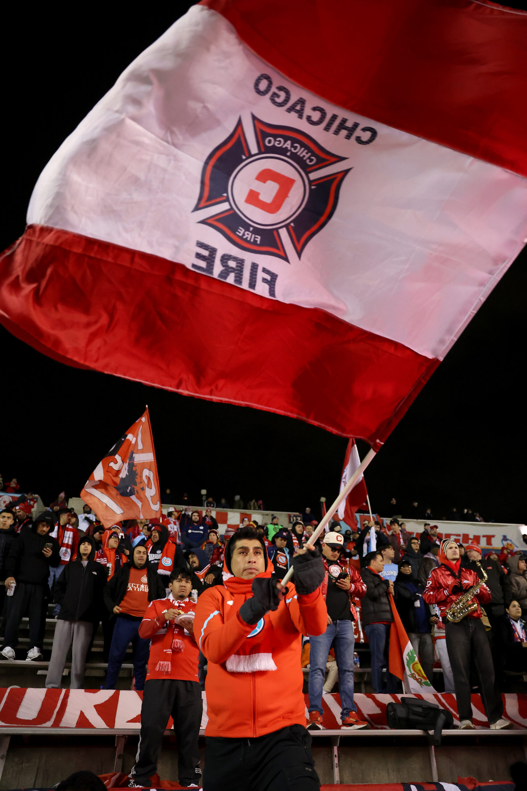 A fan waves an oversized Chicago Fire flag before the...