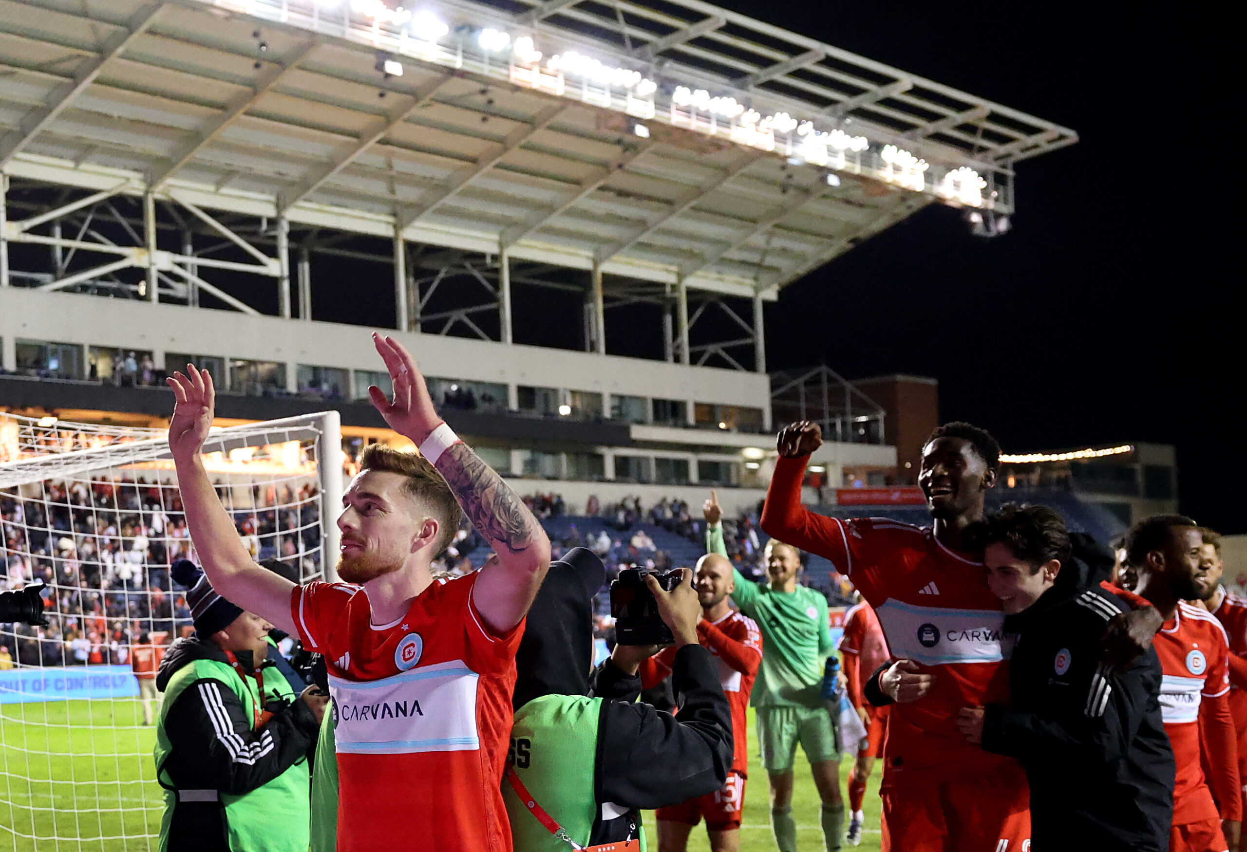 Chicago Fire defender Joel Waterman celebrates with his teammates after...