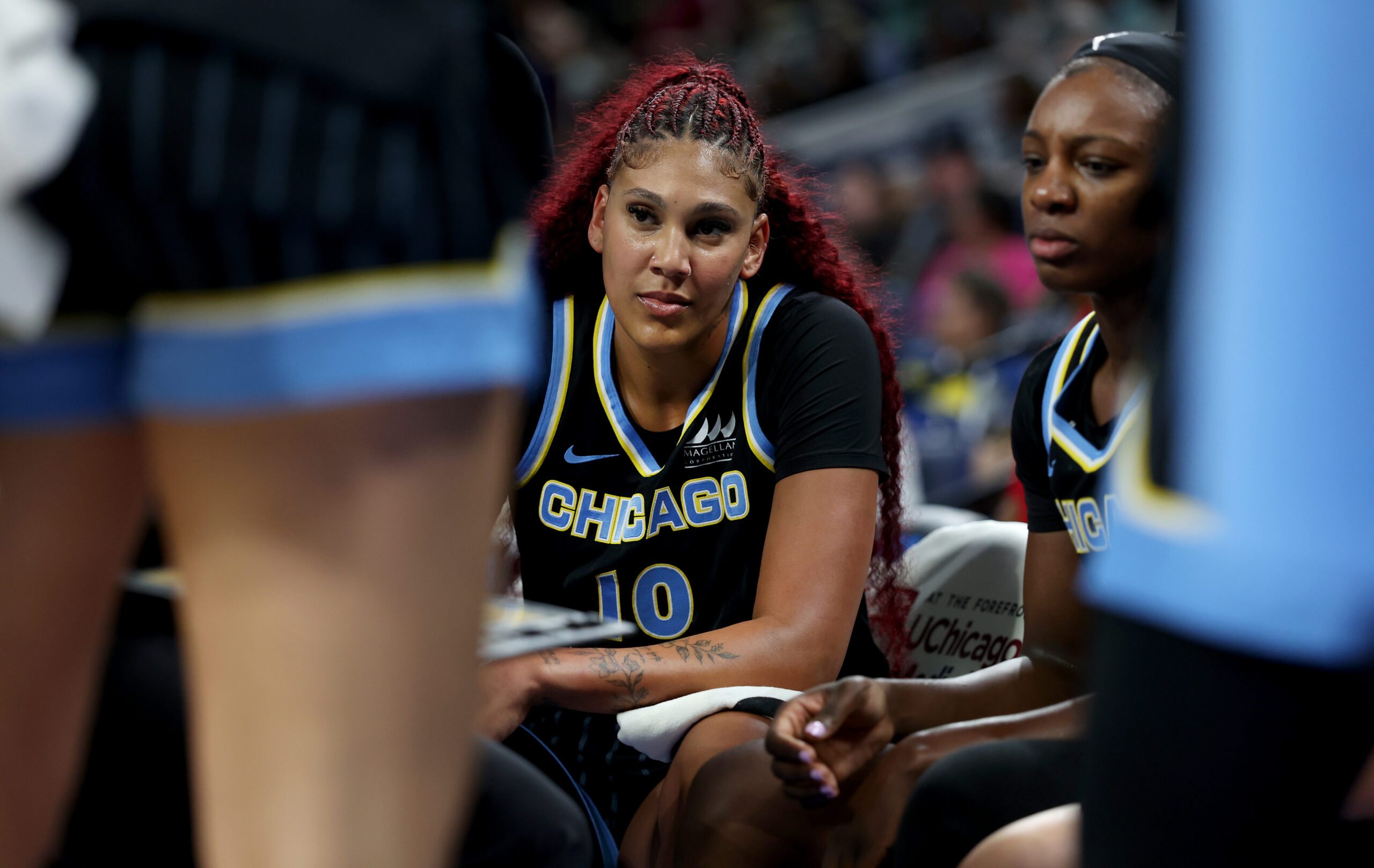 Sky center Kamilla Cardoso listens in on the bench during...