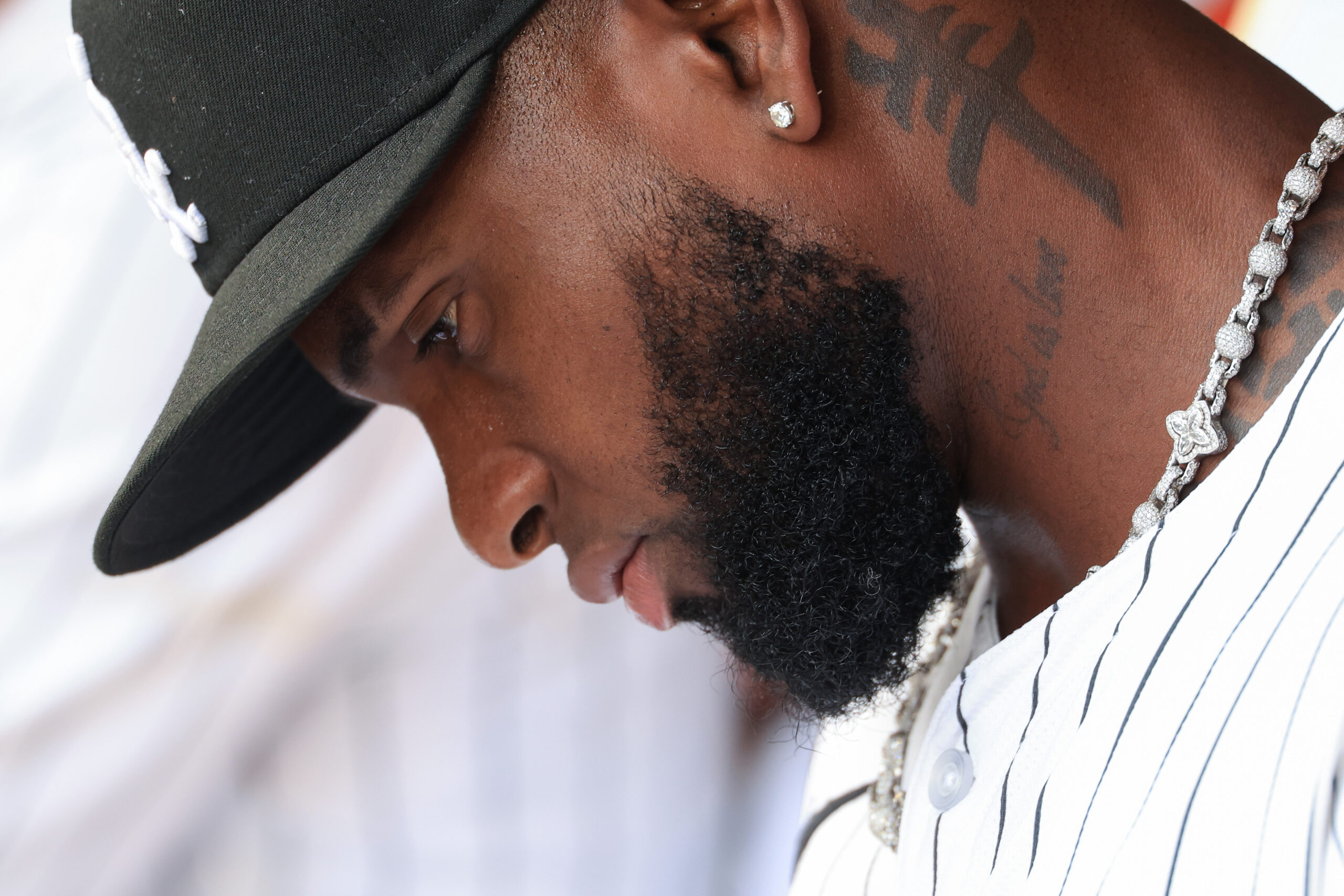White Sox center fielder Luis Robert Jr. sits in the...