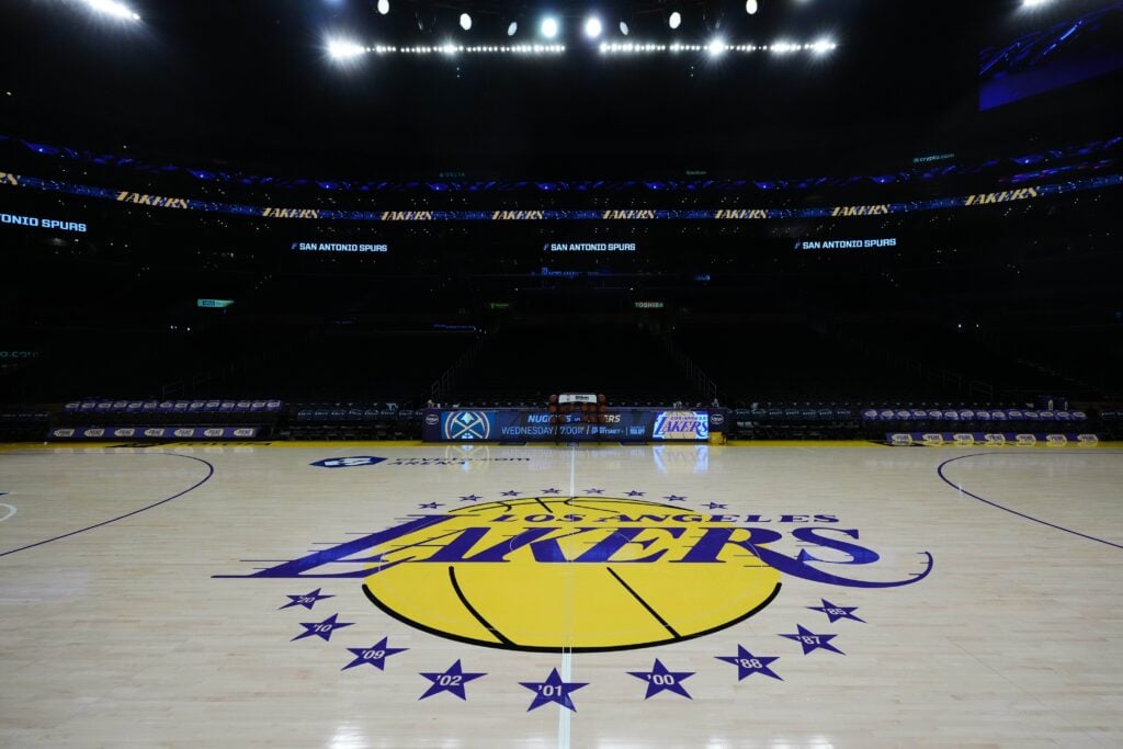 The Los Angeles Lakers logo at midcourt at Crypto.com Arena.
