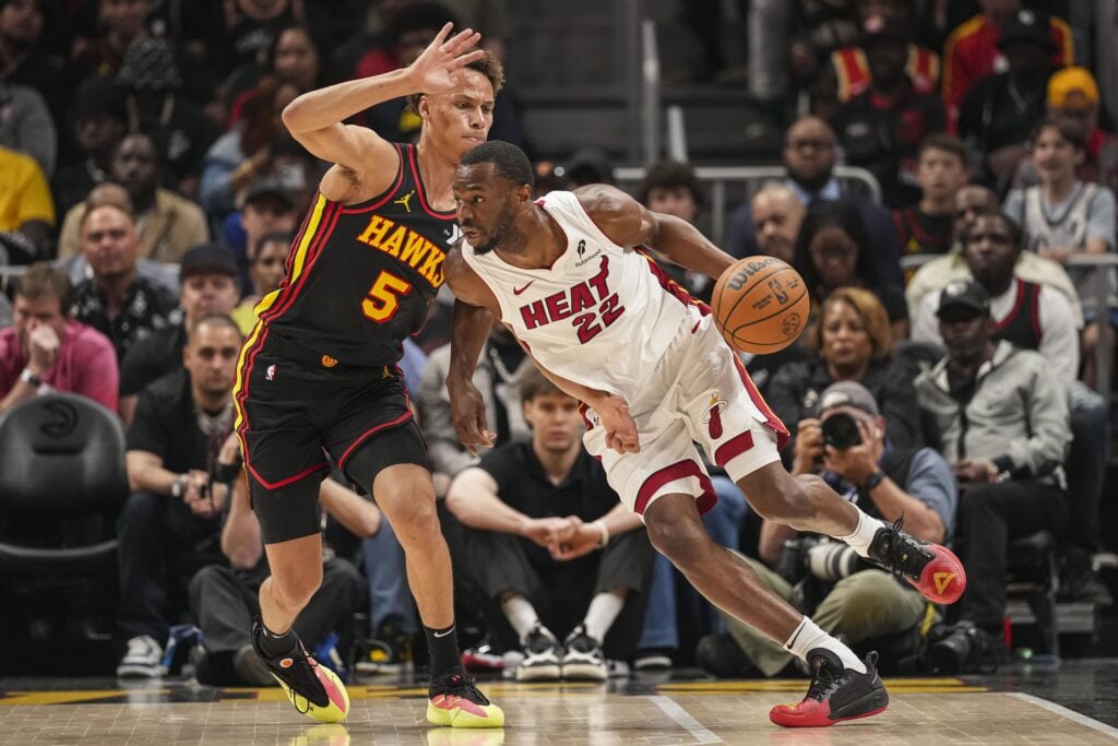Apr 18, 2025; Atlanta, Georgia, USA; Miami Heat forward Andrew Wiggins (22) dribbles against Atlanta Hawks guard Dyson Daniels (5) during the first half at State Farm Arena. Mandatory Credit: Dale Zanine-Imagn Images