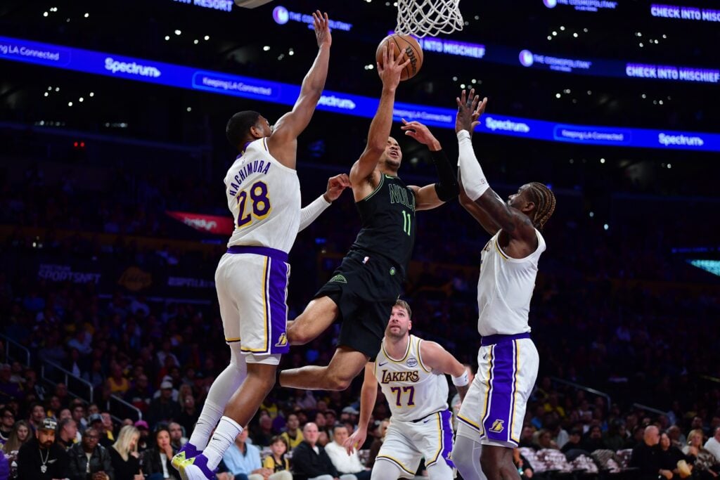 Nov 30, 2025; Los Angeles, California, USA; New Orleans Pelicans guard Bryce McGowens (11) moves to the basket against Los Angeles Lakers forward Rui Hachimura (28) and center Deandre Ayton (5) during the second half at Crypto.com Arena. Mandatory Credit: Gary A. Vasquez-Imagn Images