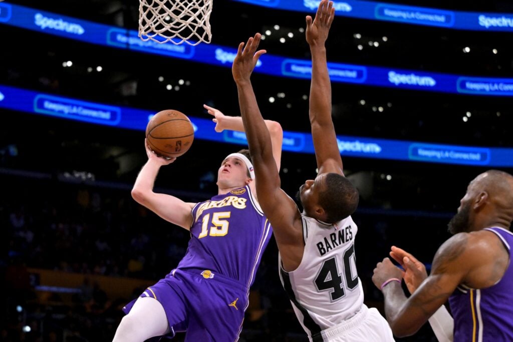 Dec 10, 2025; Los Angeles, California, USA; Los Angeles Lakers guard Austin Reaves (15) is fouled by San Antonio Spurs forward Harrison Barnes (40) as he makes a shot during the second half at Crypto.com Arena. Mandatory Credit: Jayne Kamin-Oncea-Imagn Images
