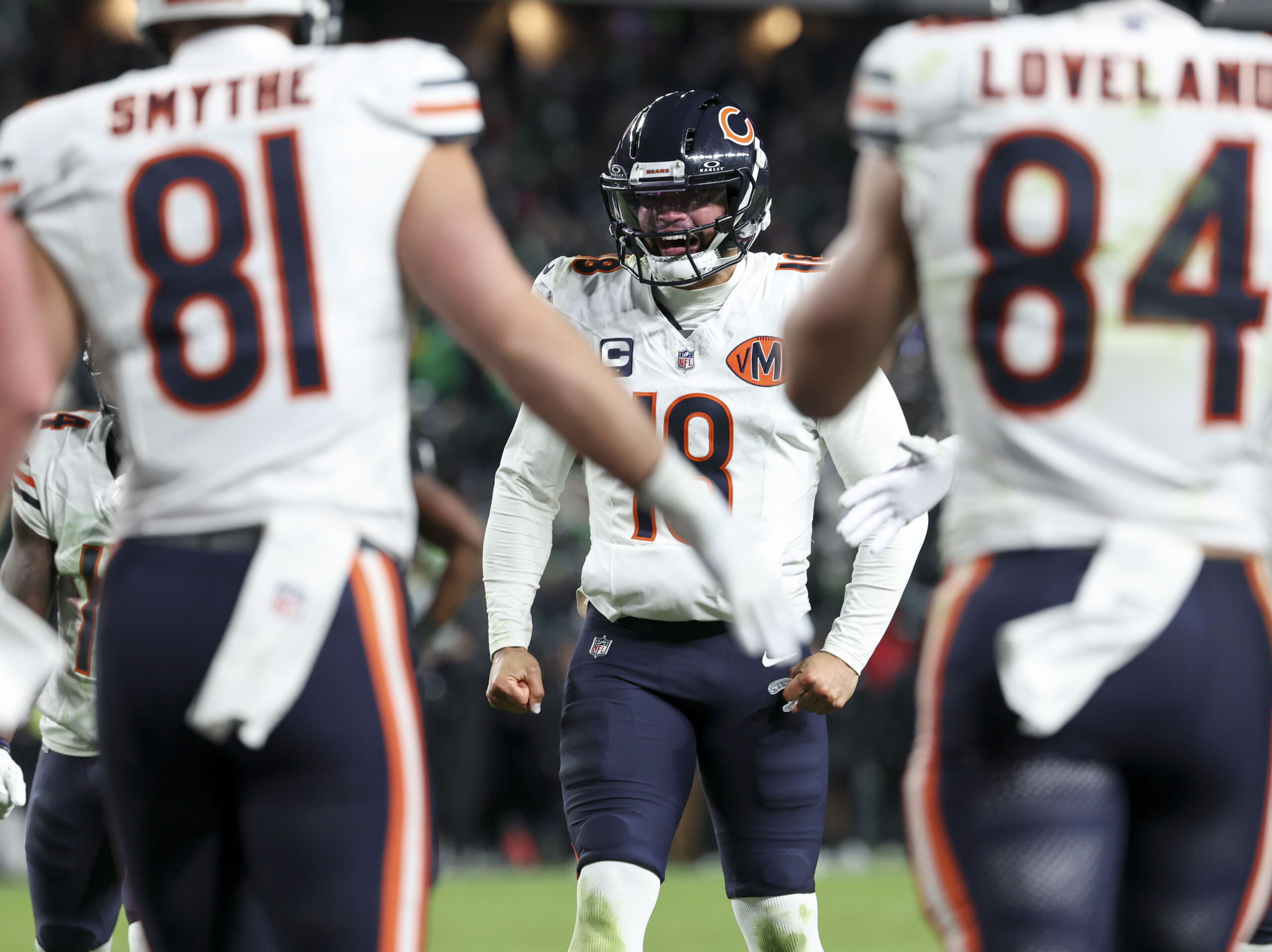 Bears quarterback Caleb Williams celebrates his touchdown throw to Cole...