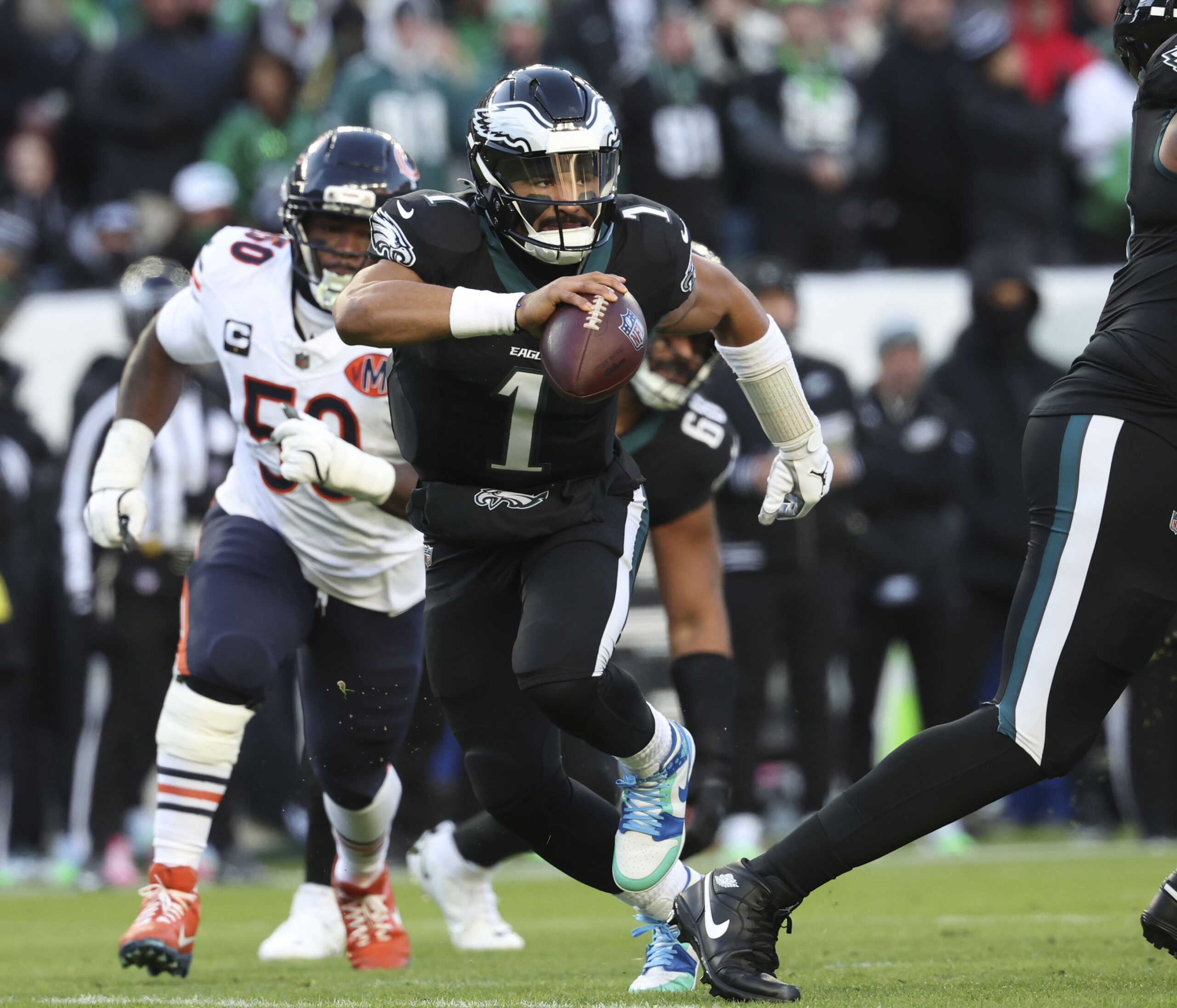 Philadelphia Eagles quarterback Jalen Hurts (1) scrambles against the Chicago...