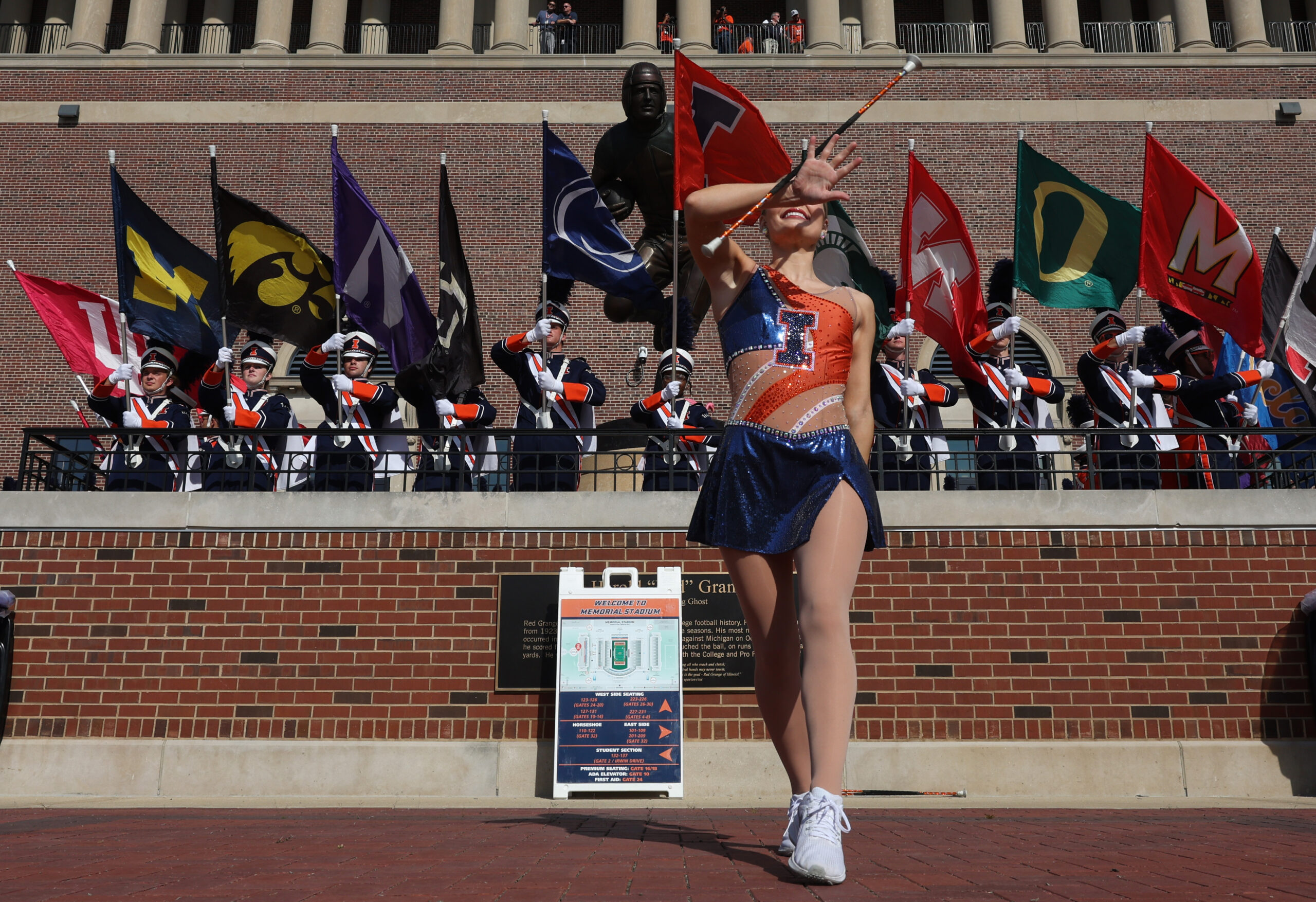 An Illinois marching band majorette performs during the team walk-in...