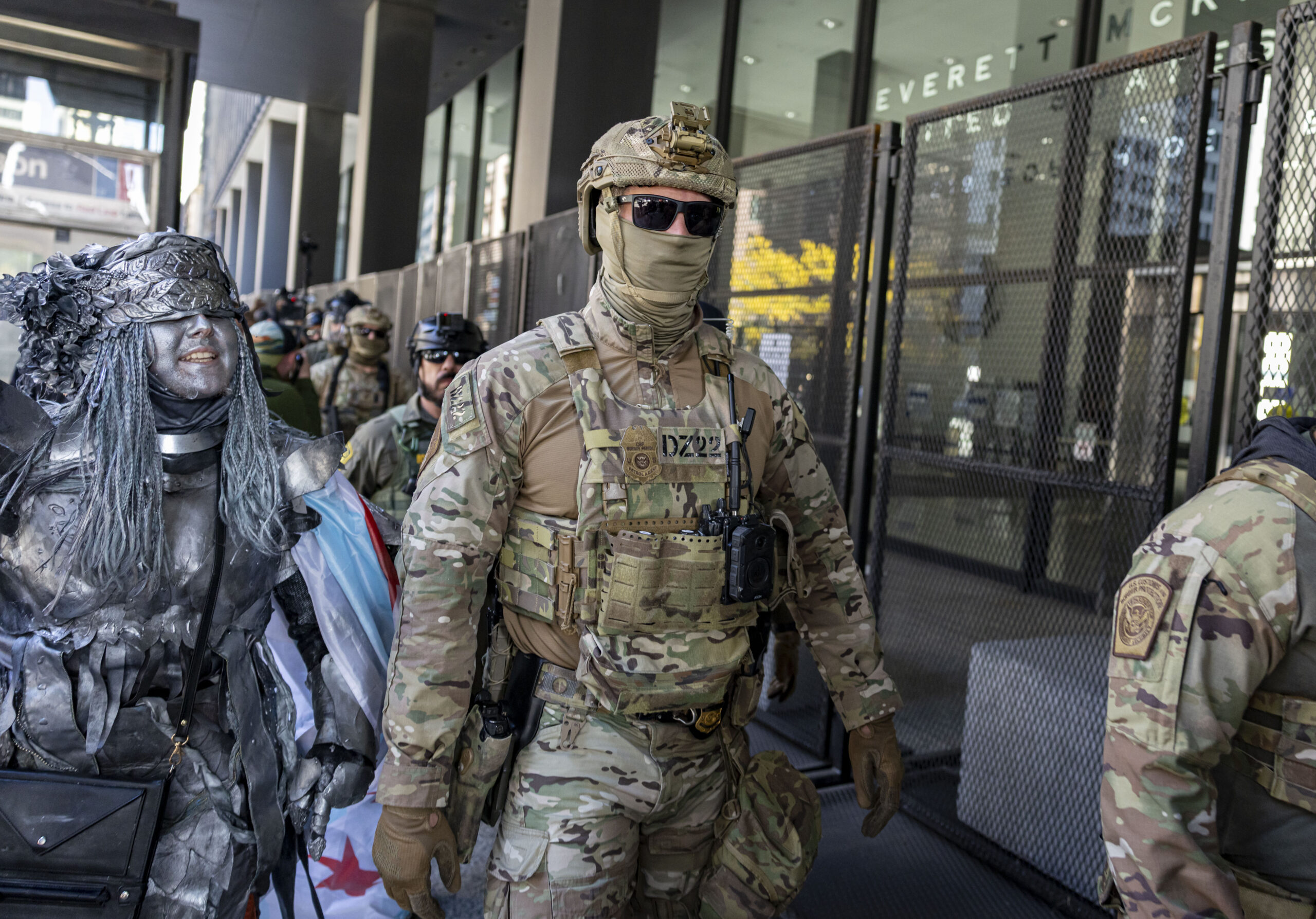 A protester watches as Border Patrol agents arrive to escort...