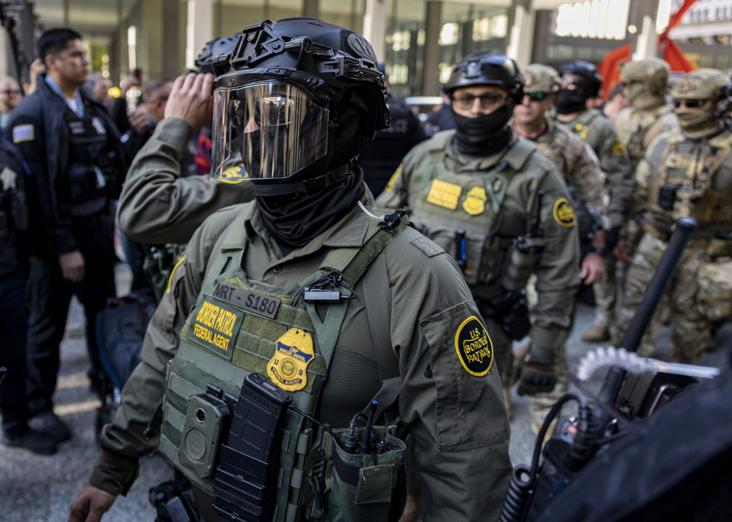Border Patrol agents arrive to escort Cmdr. Gregory Bovino from...