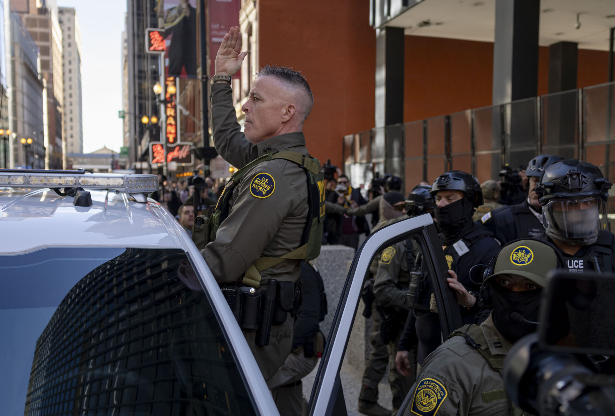 Border Patrol Cmdr. Gregory Bovino signals to other agents as he leaves the Dirksen U.S. Courthouse after testifying on Oct. 28, 2025. (Brian Cassella/Chicago Tribune)