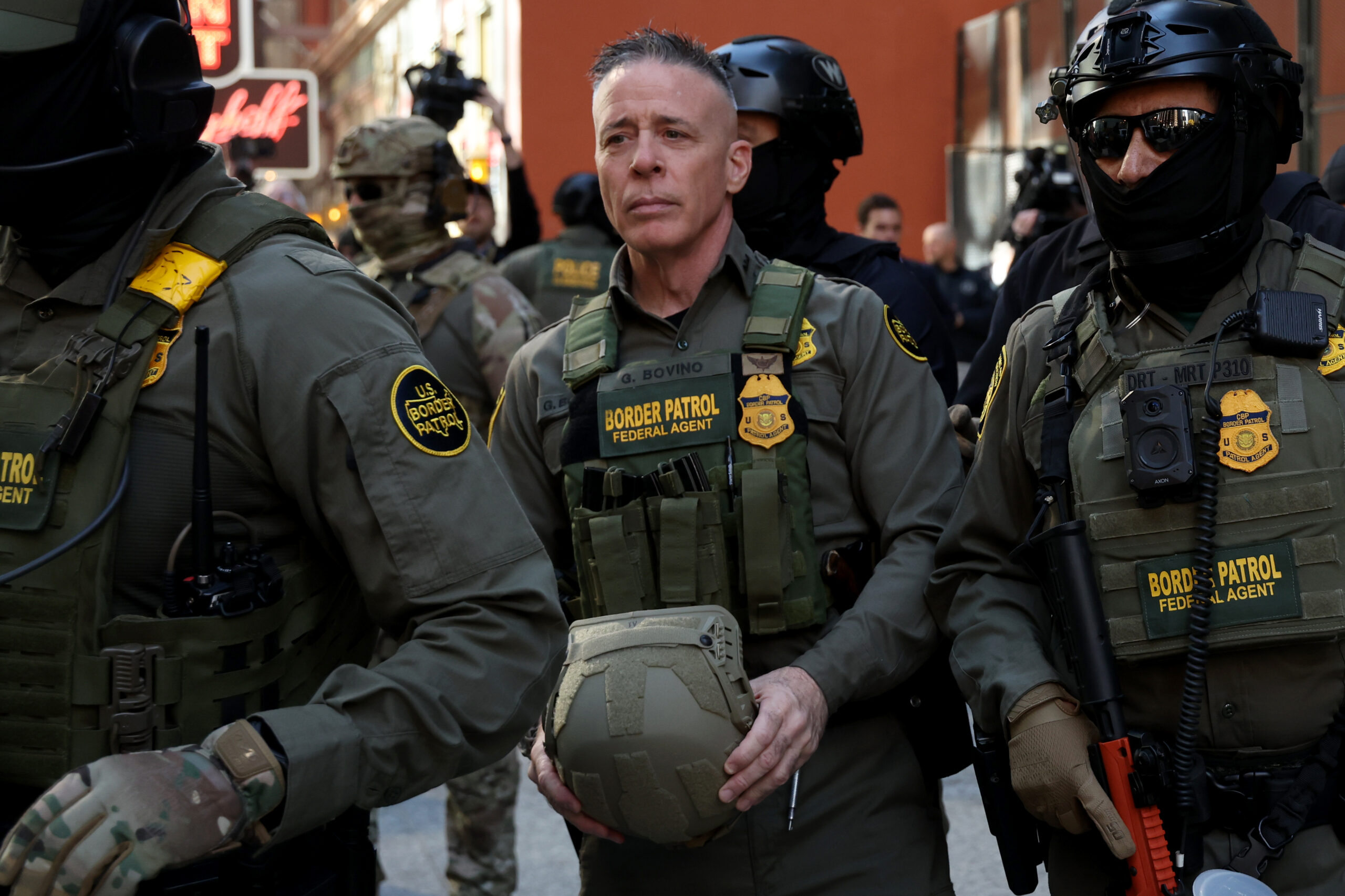 Border Patrol Cmdr. Gregory Bovino, center, exits the Dirksen U.S....