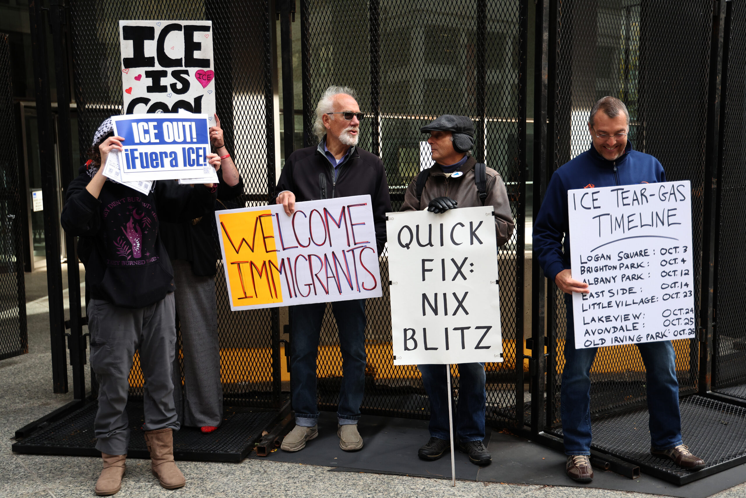 Protesters stand outside the fencing surrounding the Dirksen U.S. Courthouse...