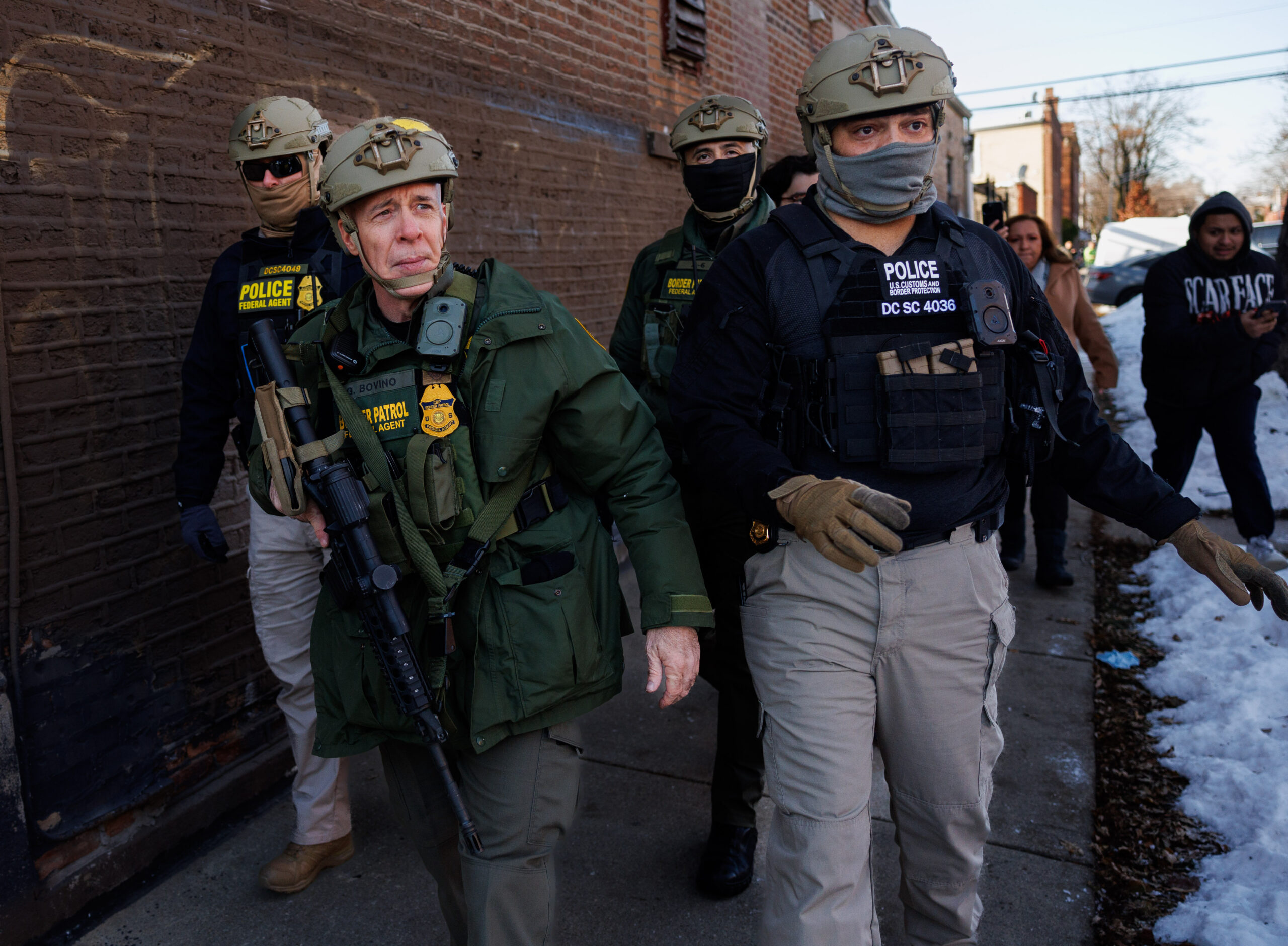 U.S. Border Patrol Cmdr. Gregory Bovino walks with other agents...