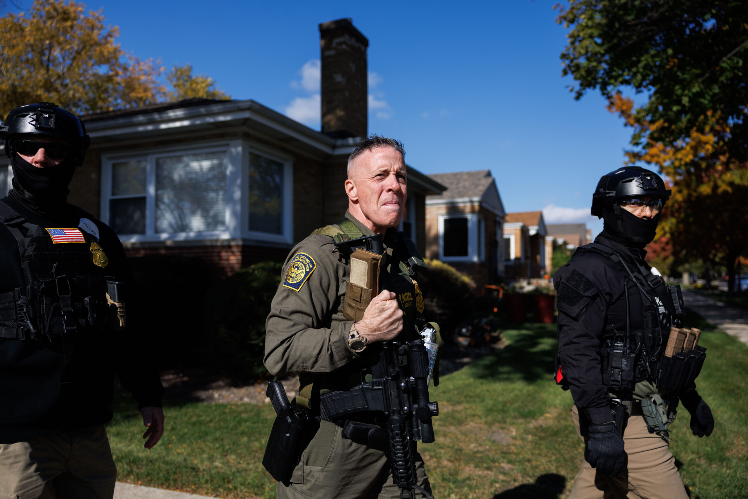 Border Patrol Cmdr. Gregory Bovino walks with agents conducting immigration...